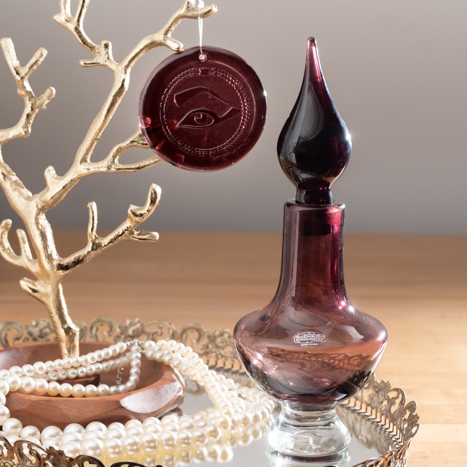 Amethyst decanter beside a purple suncatcher