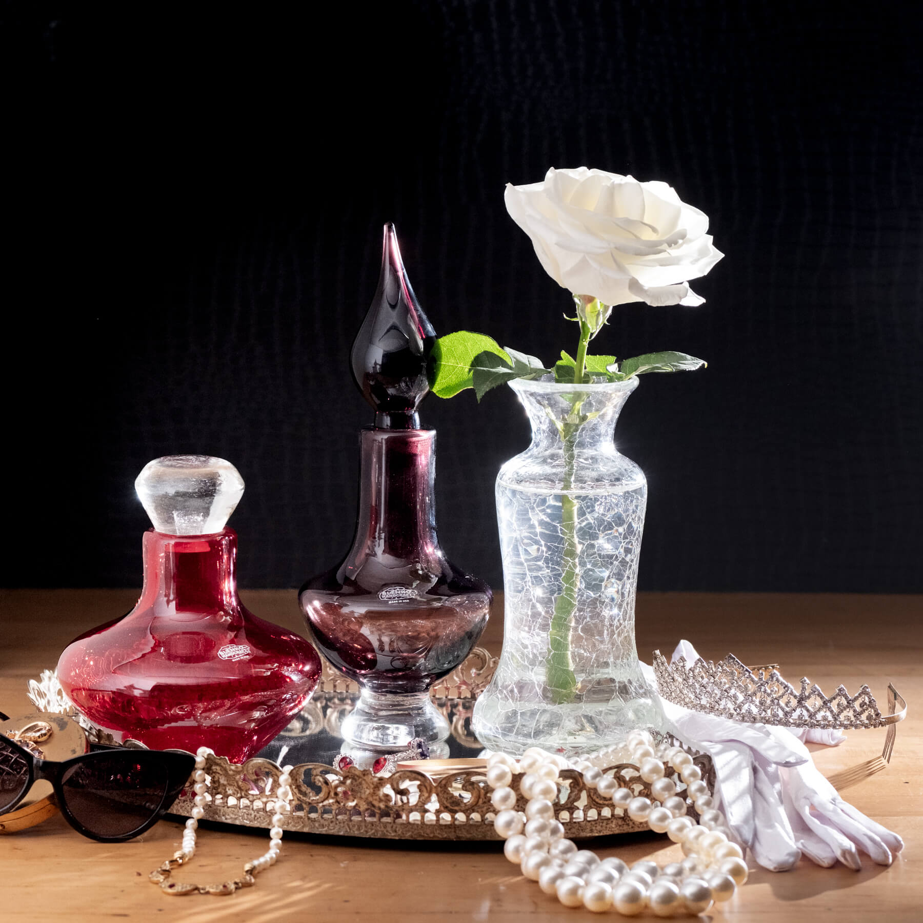Three glass items on black background