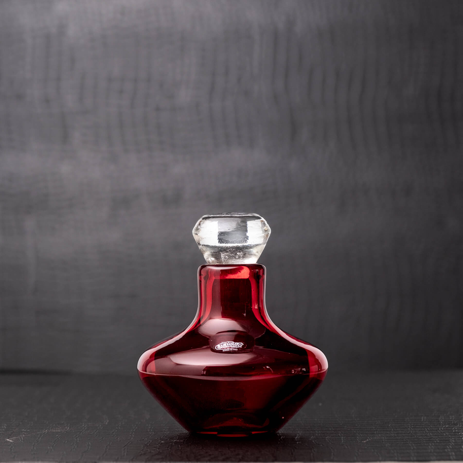 Red decanter on black background