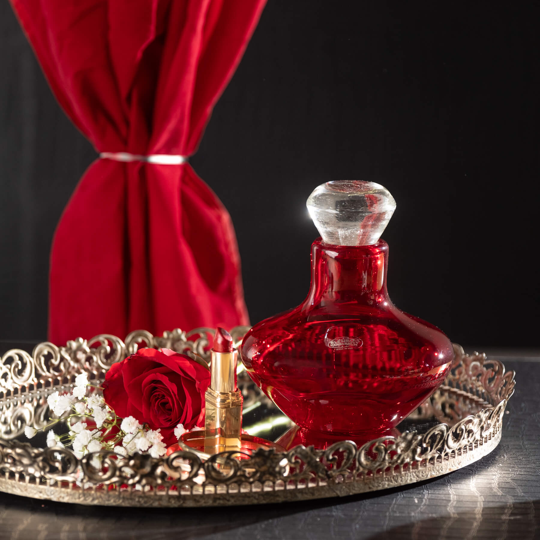 Red decanter on black background