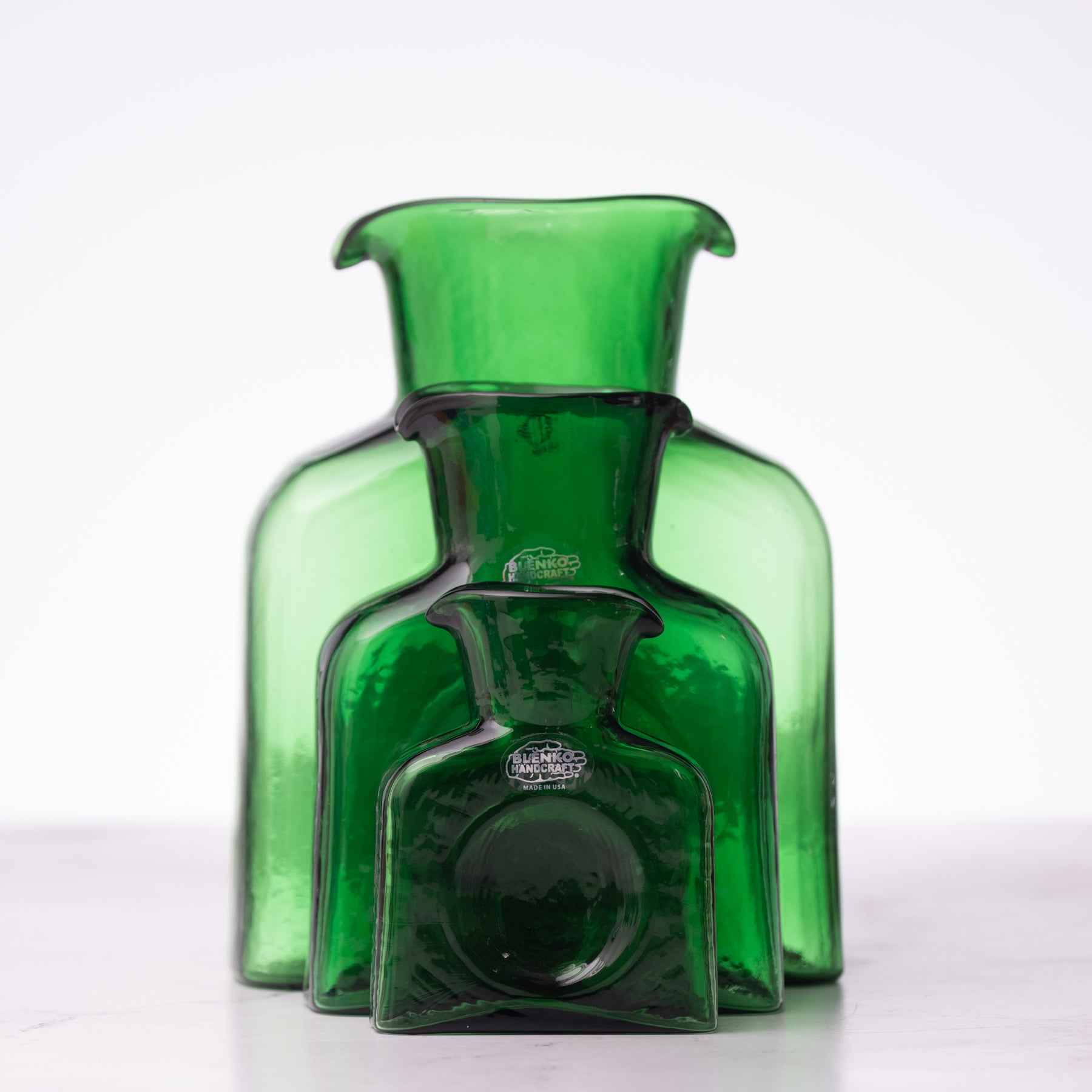 Green glass bottle on a white background