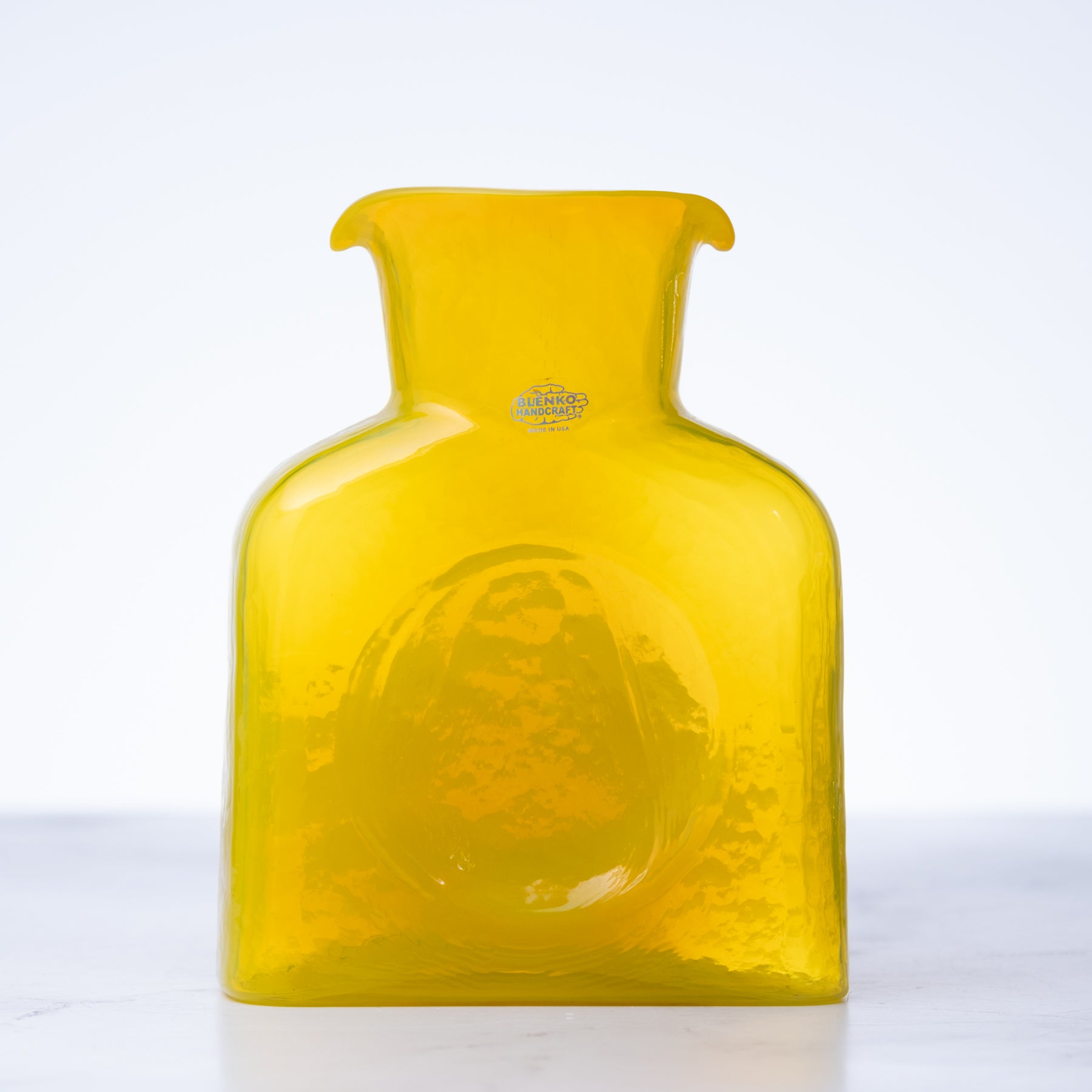 Yellow glass vase with a logo on a white background
