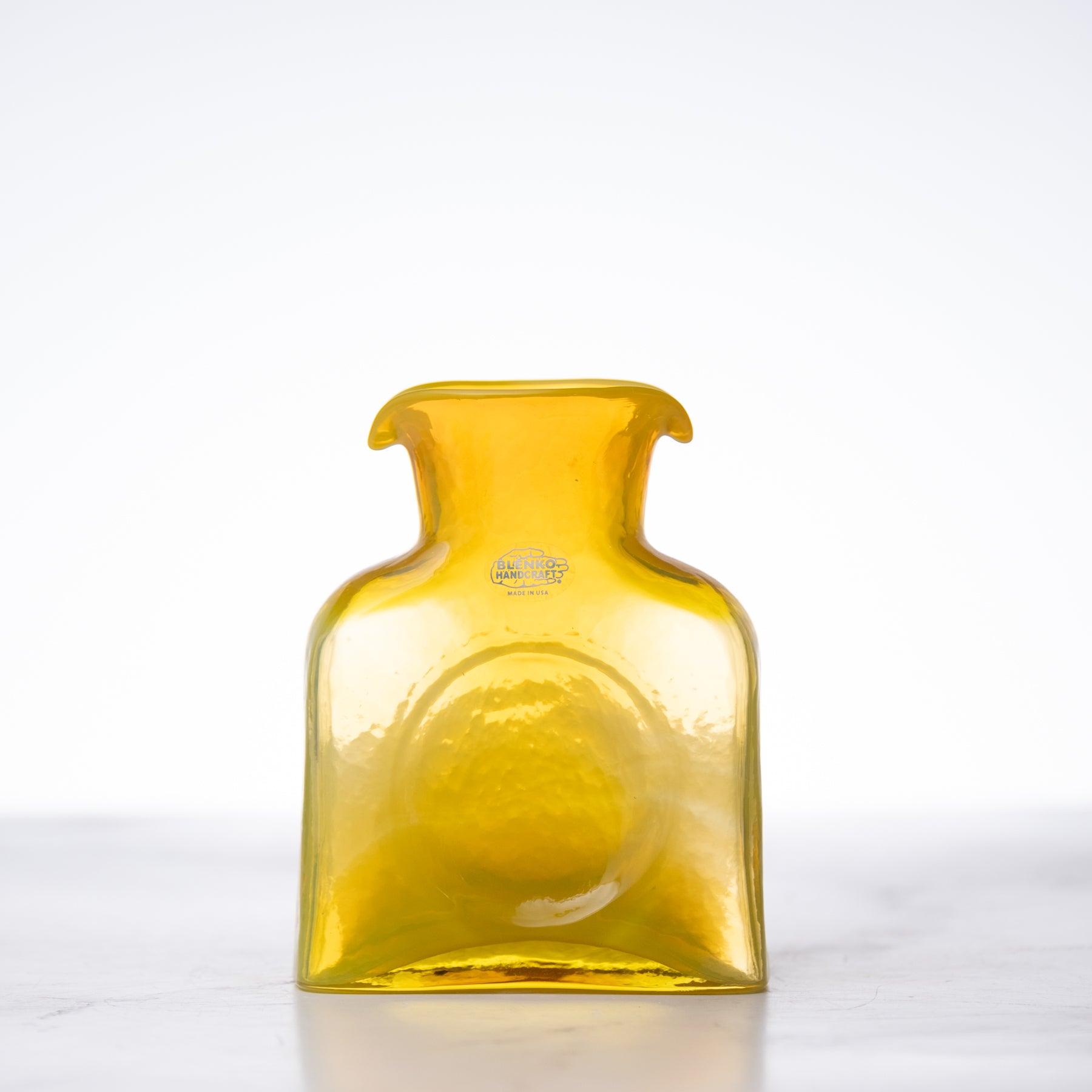 Yellow glass bottle on a white background