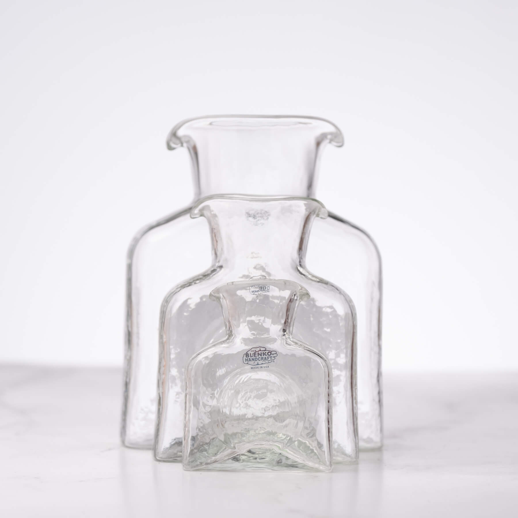 Clear glass bottle with visible branding on a white background
