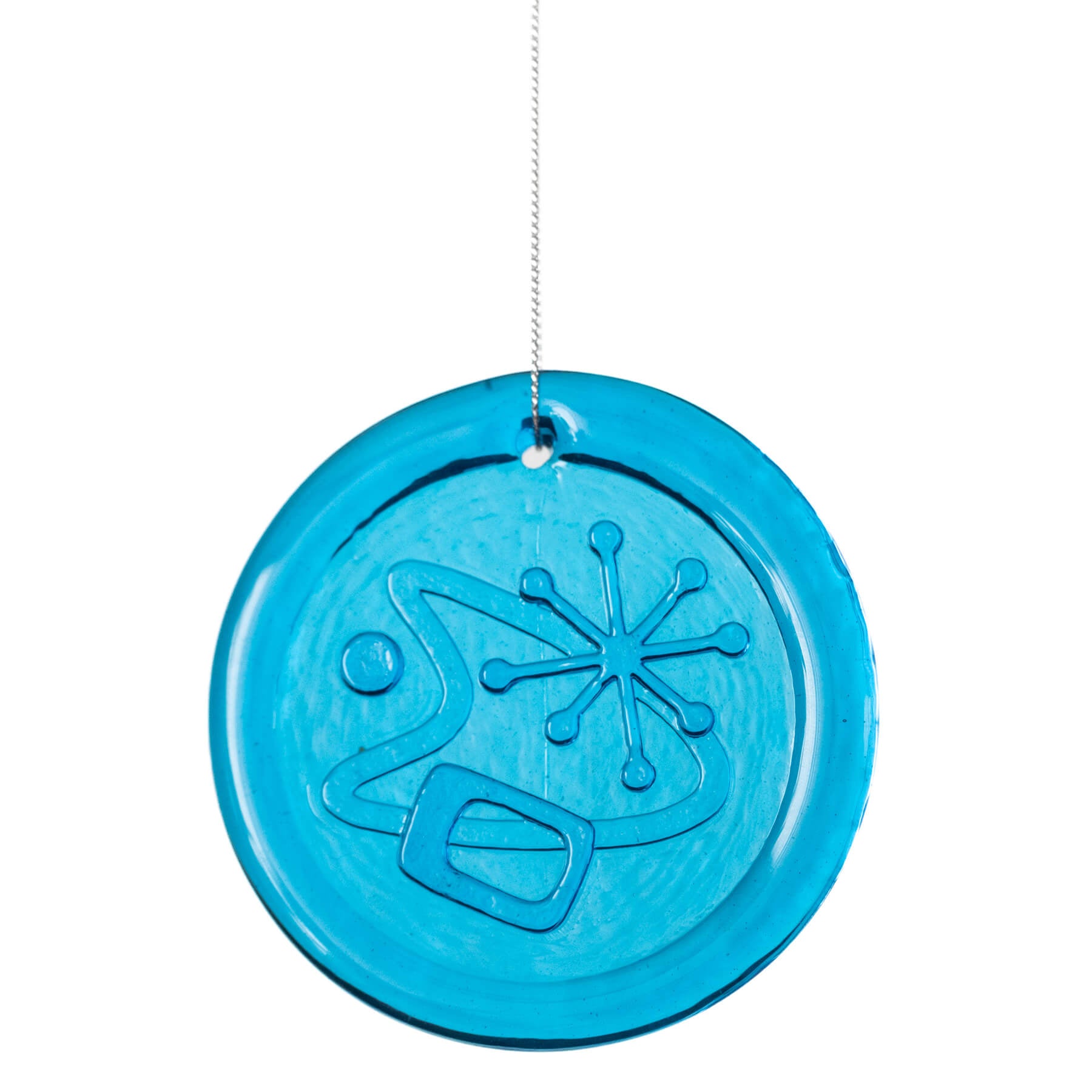 Blue circular ornament with snowflake design on a white background
