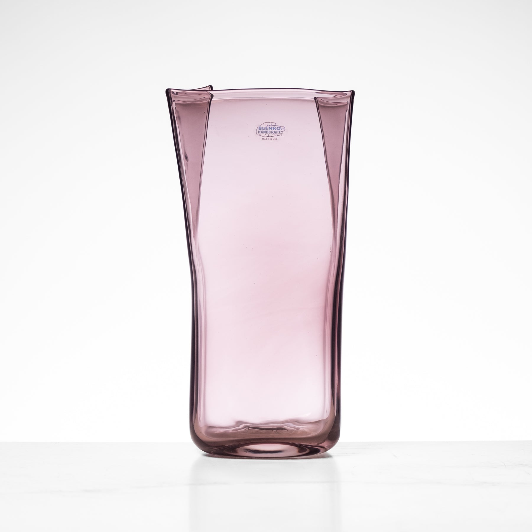 Pink glass vase on a white background