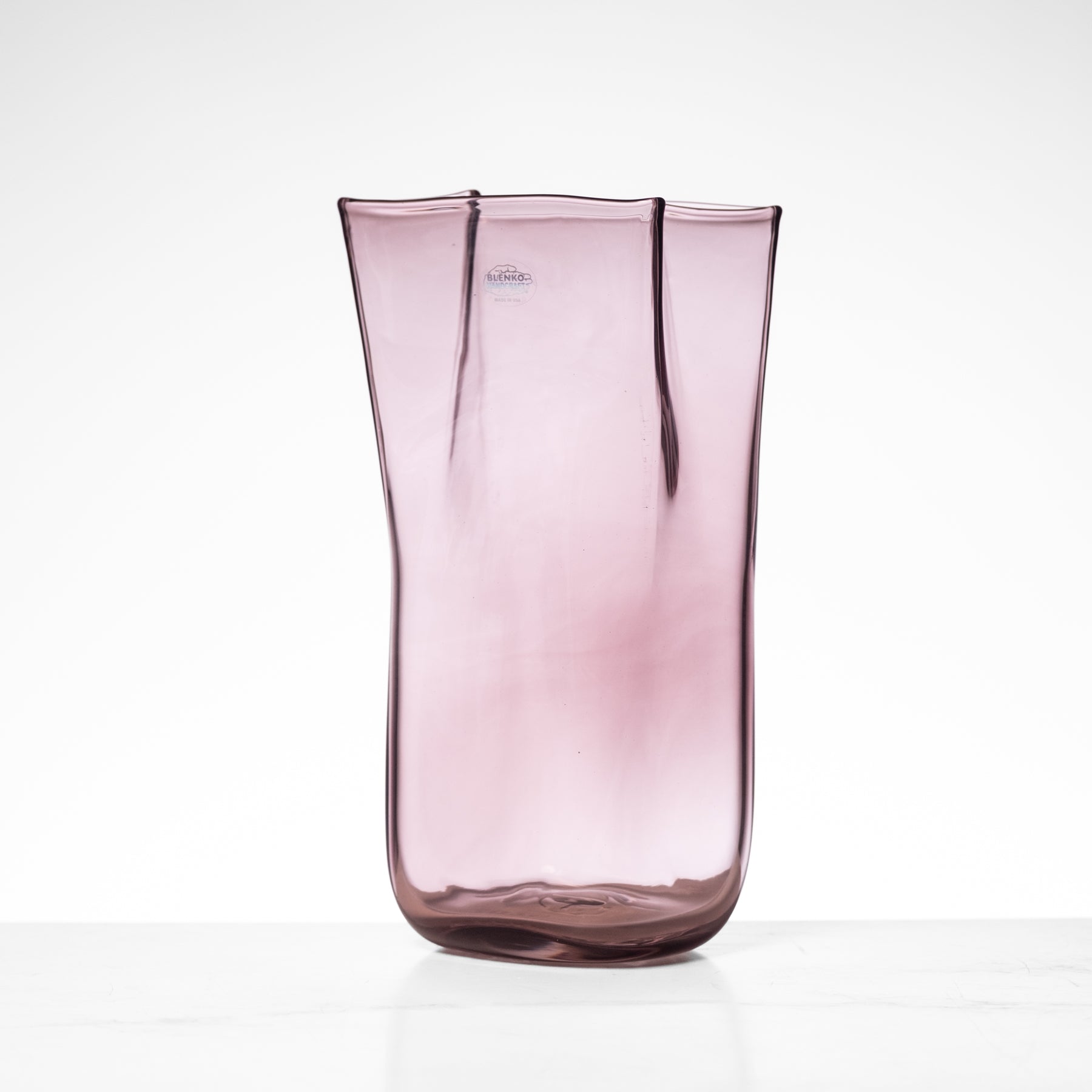Pink glass vase on a white background