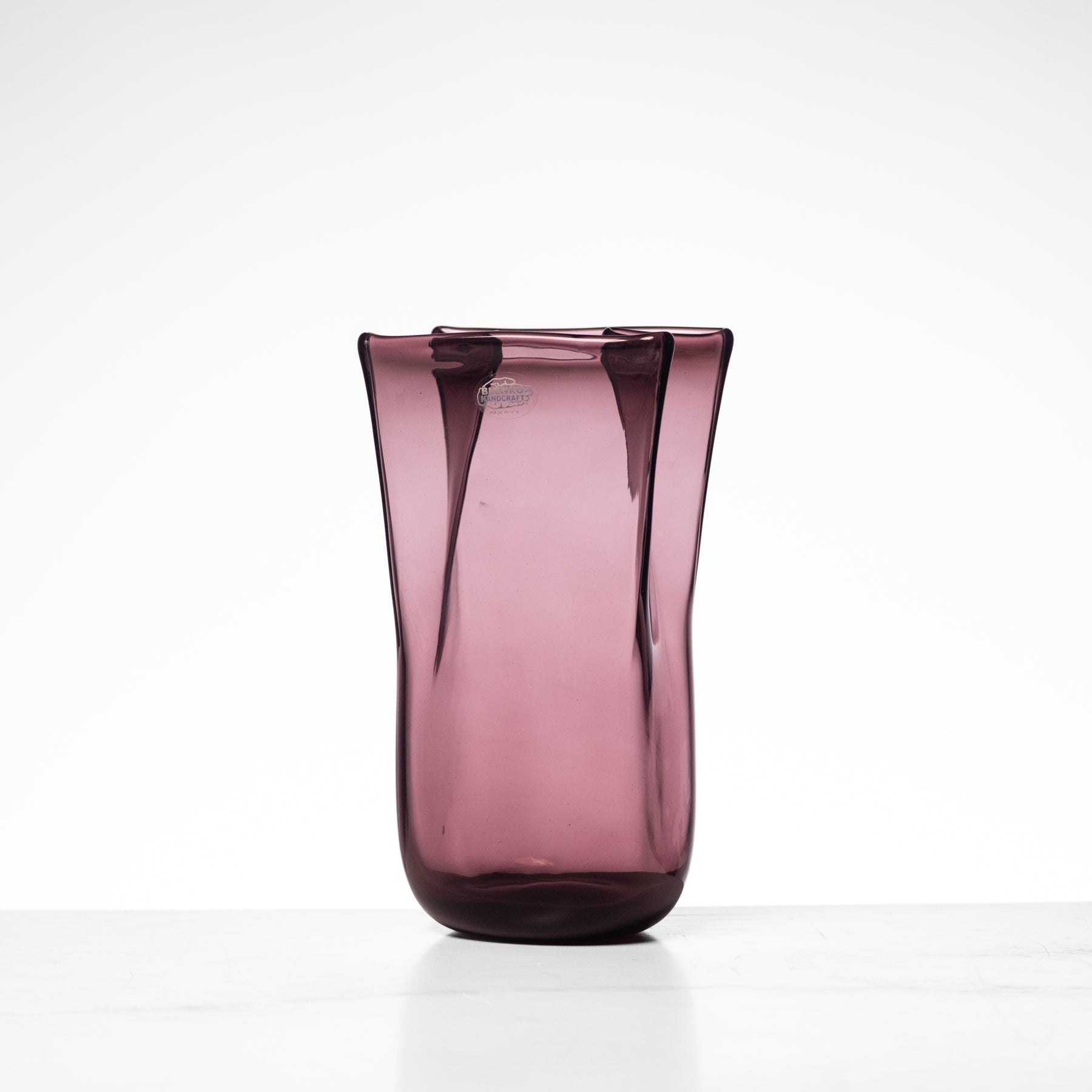 Purple glass vase on a white background