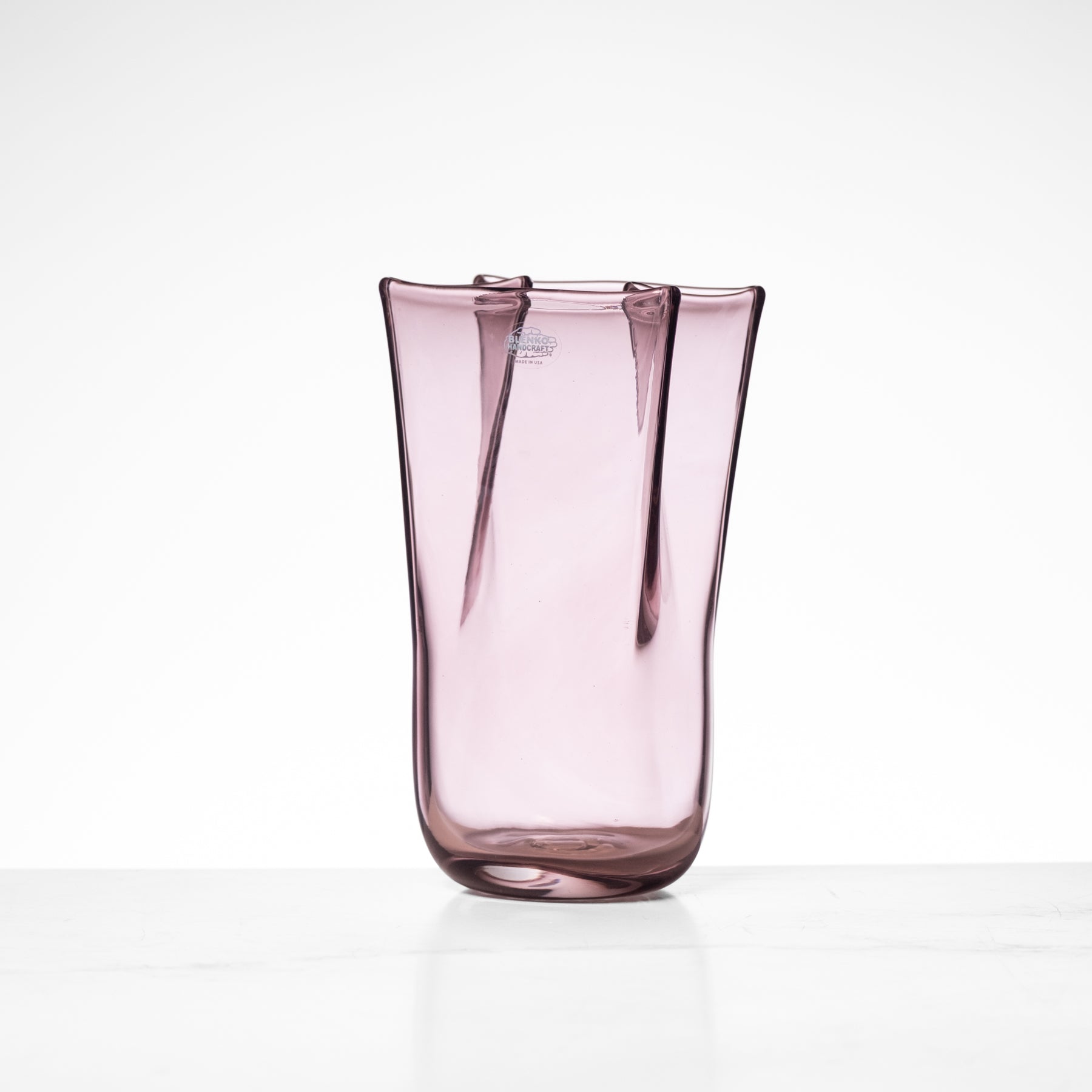 Pink glass vase on a white background