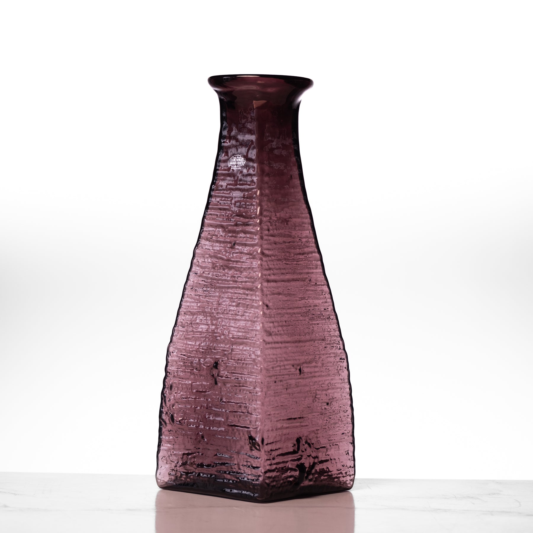 Purple textured vase on a white background