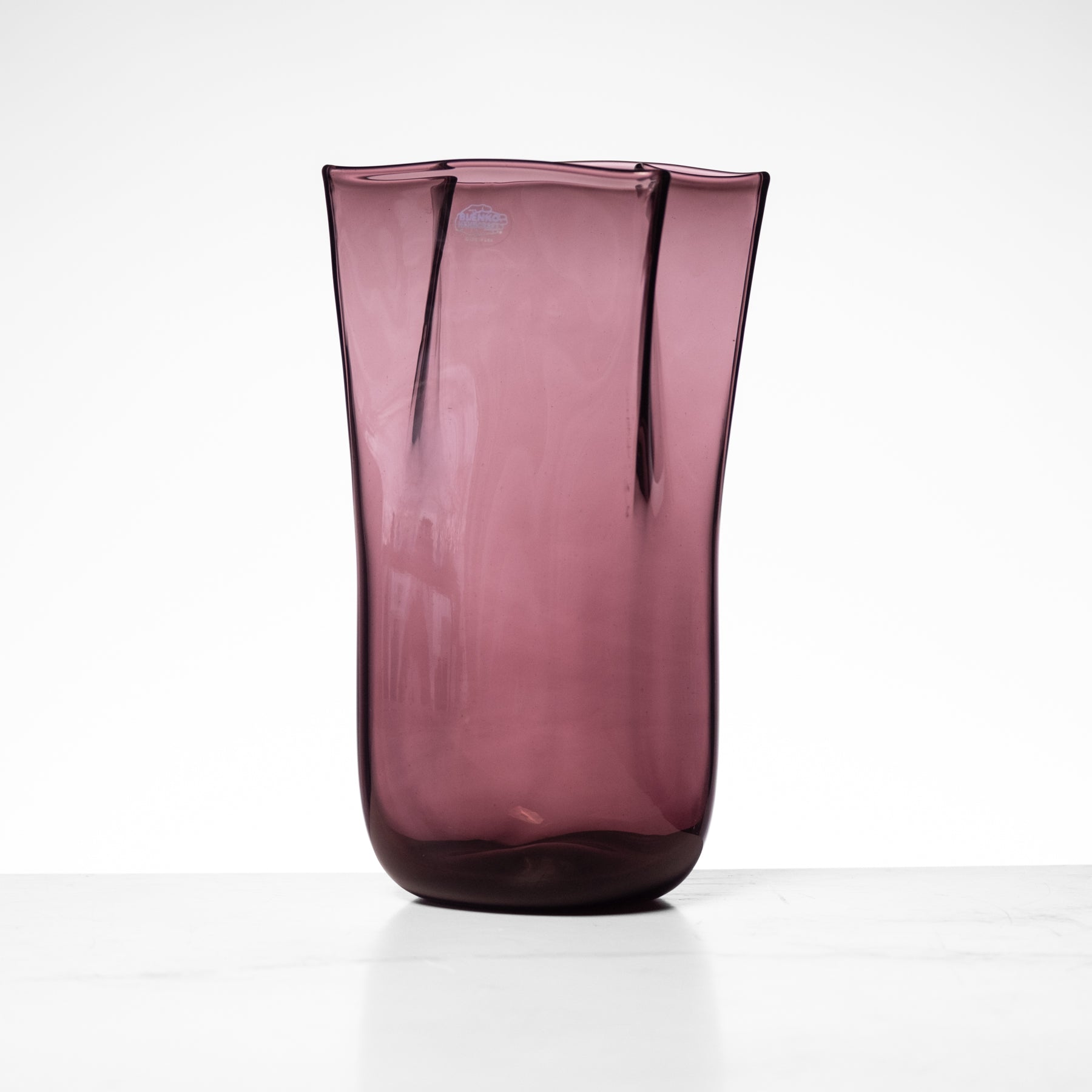 Purple glass vase on a white background