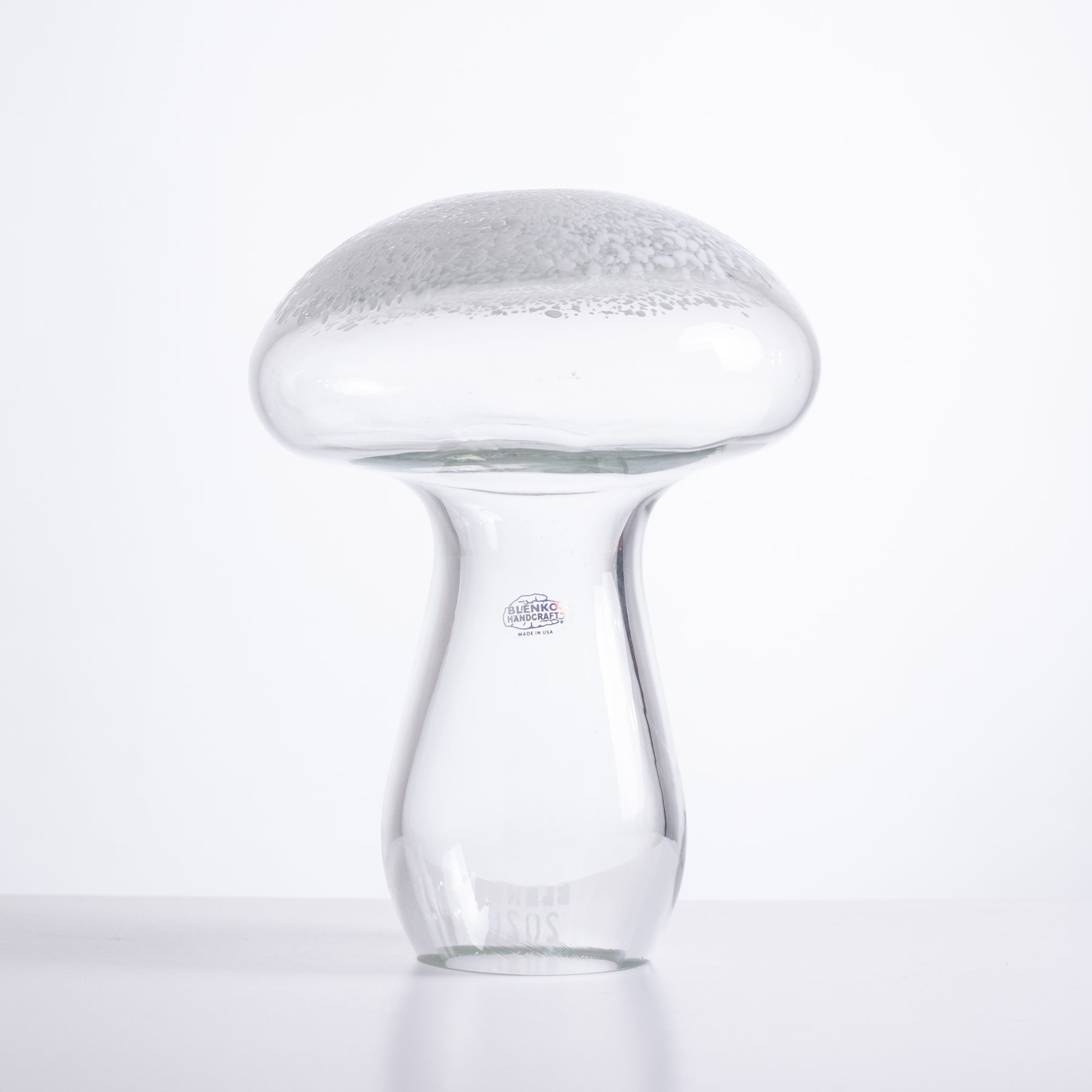 Glass mushroom-shaped object on a white background