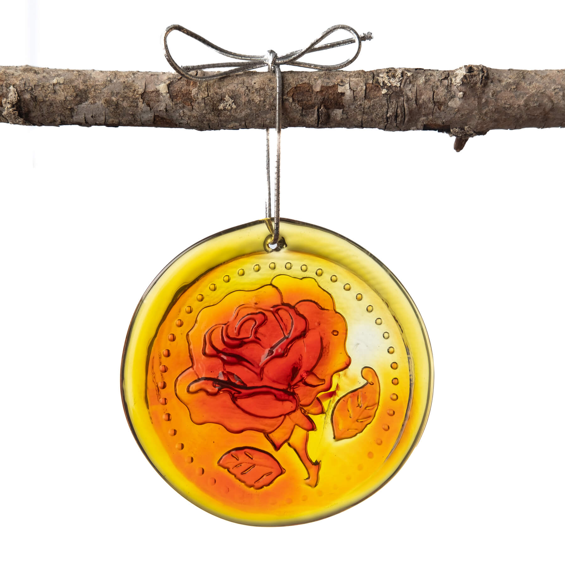 A handcrafted glass suncatcher with a rose design, in orange and yellow hues, hanging by a string