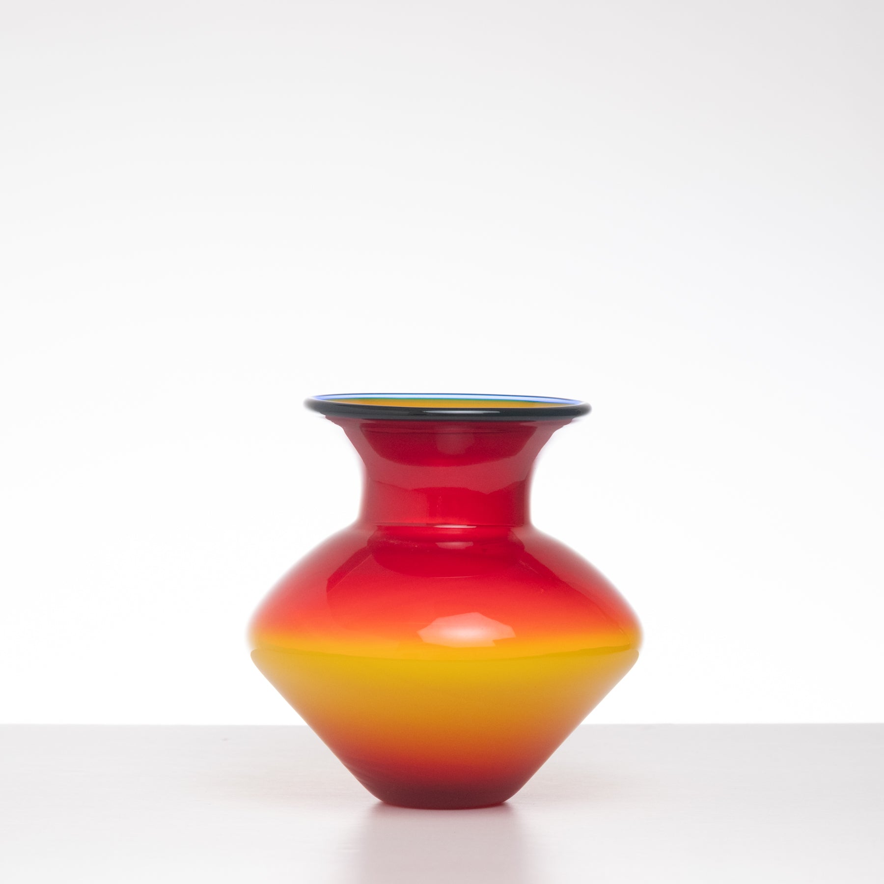 Vibrant red and yellow vase on a white background