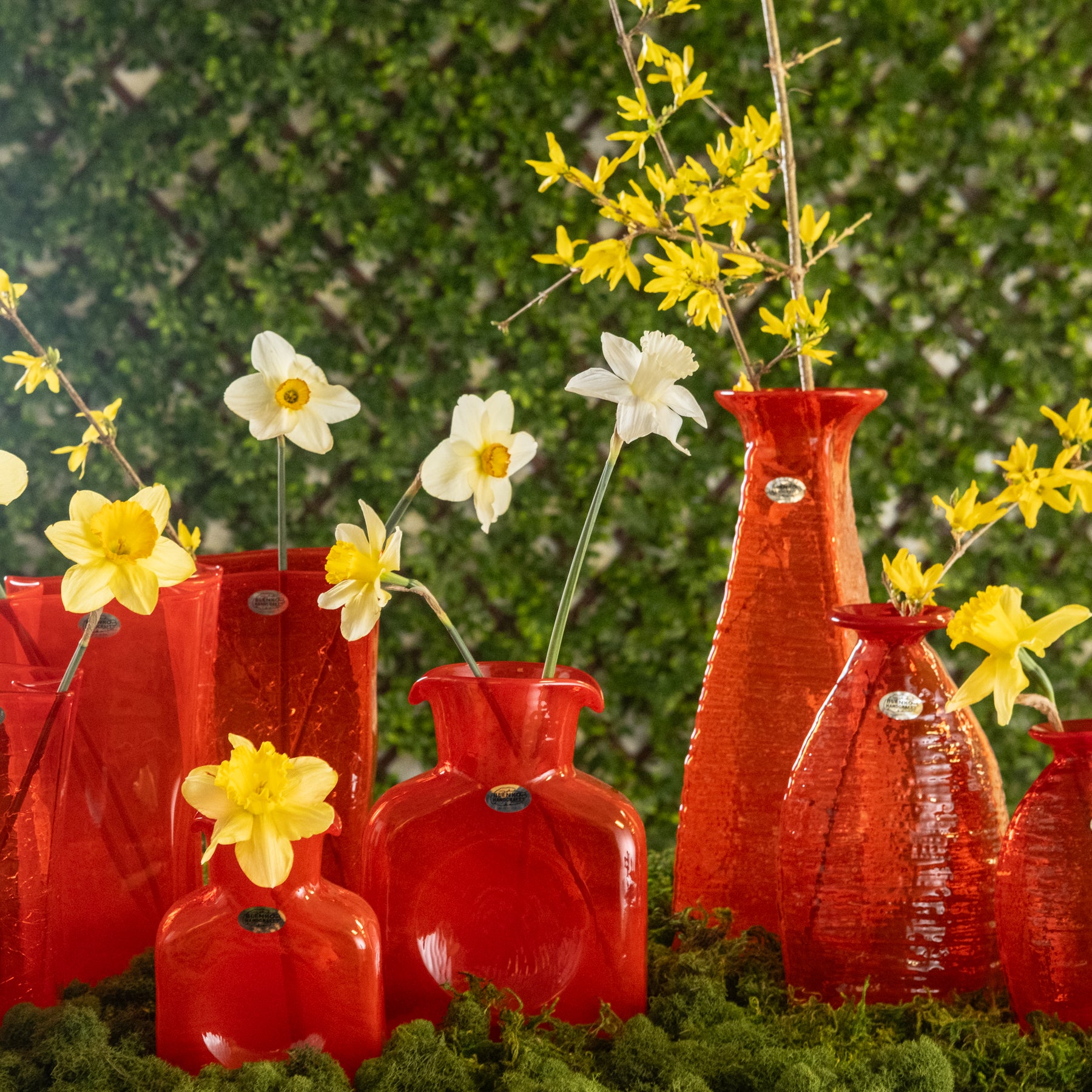 Orange bottles with yellow flowers in an outside setting