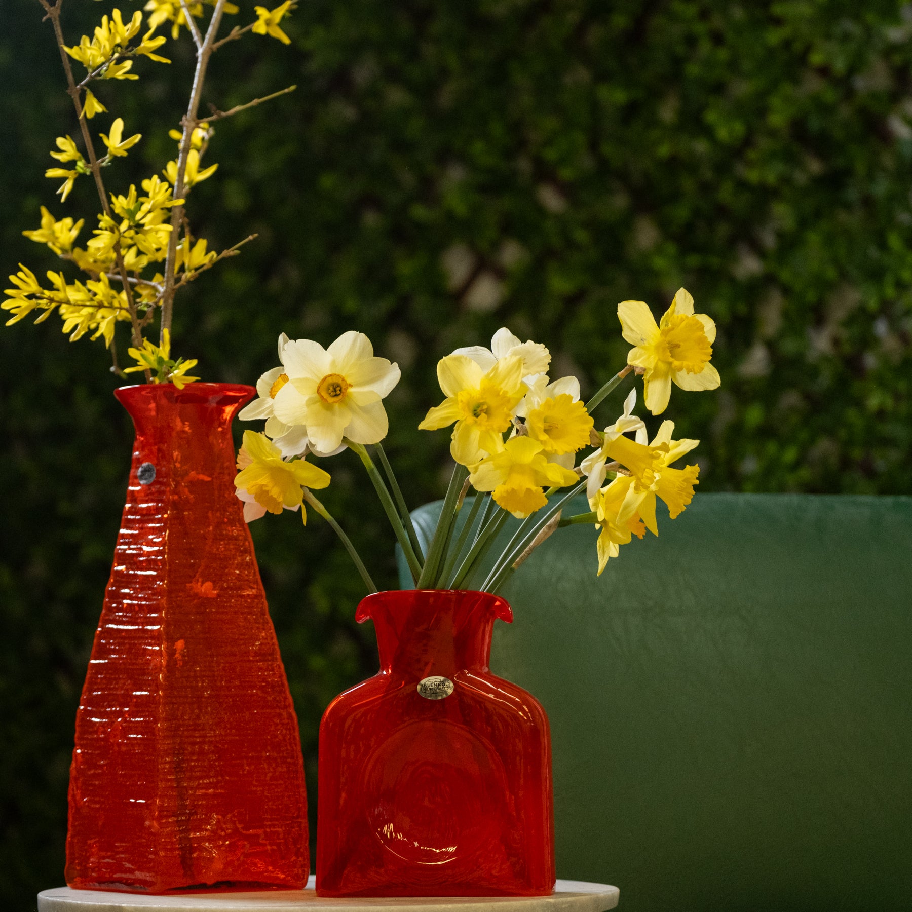 Orange bottles with yellow flowers in an outside setting
