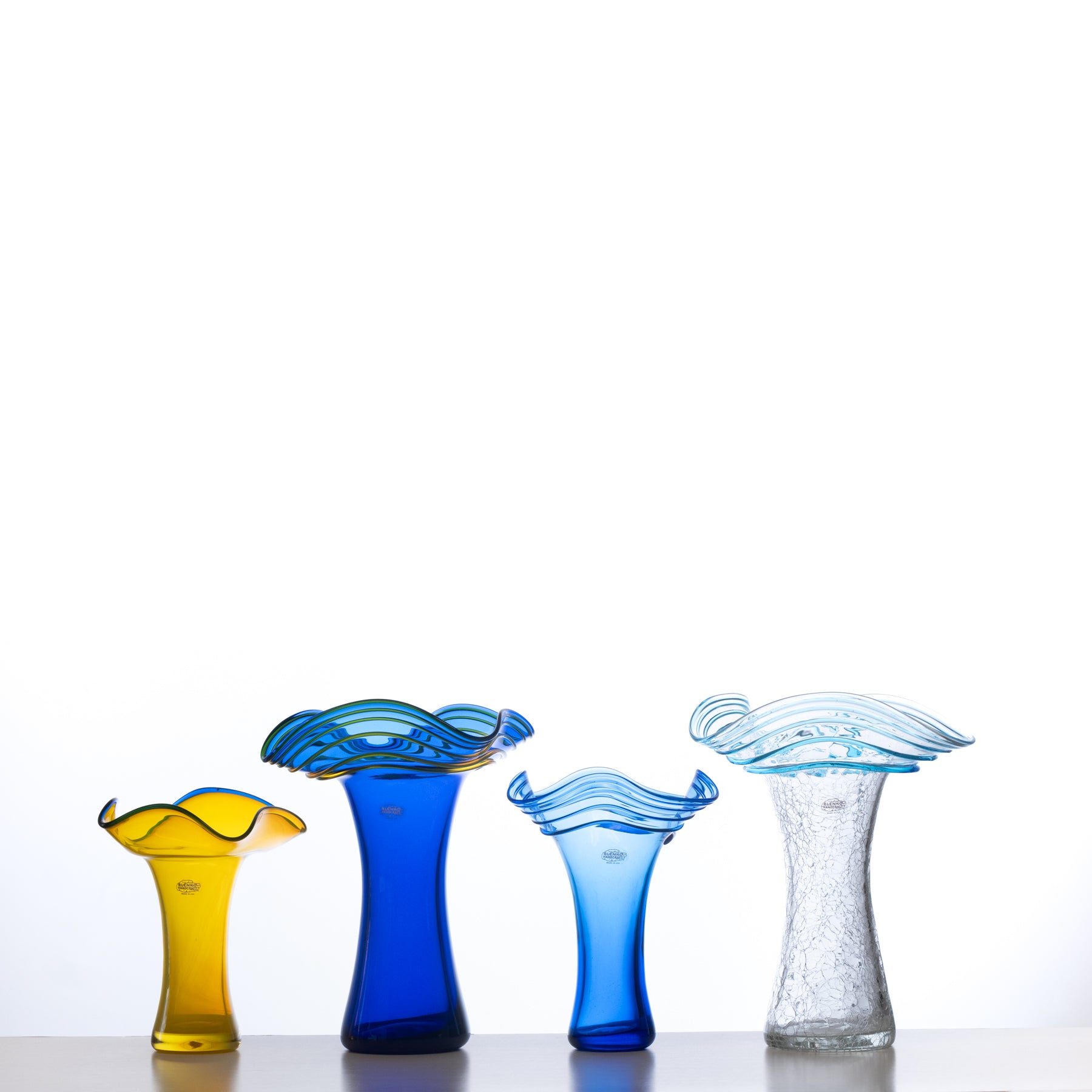 Four colorful glass vases on a white background