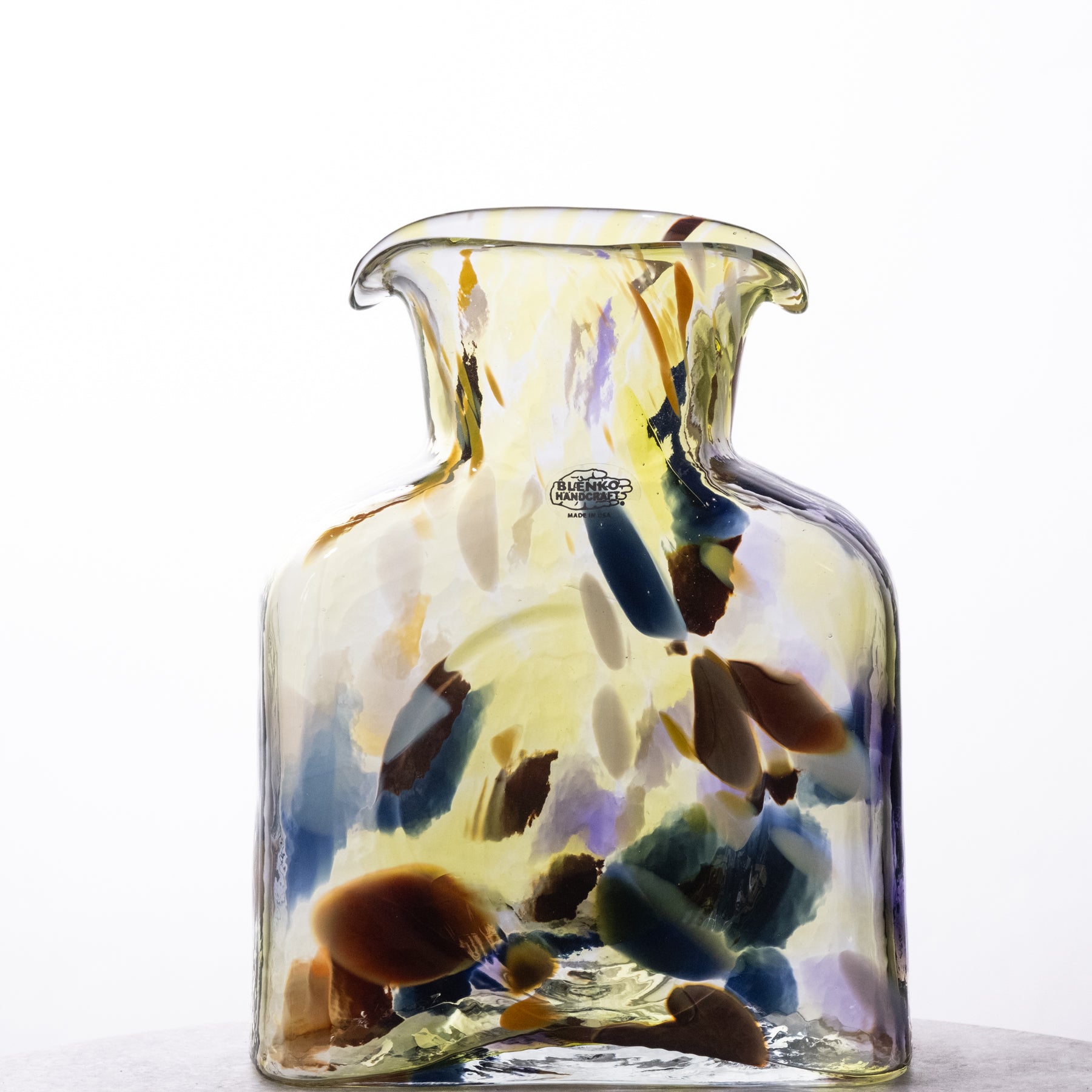 Glass vase with multicolored design on a white background