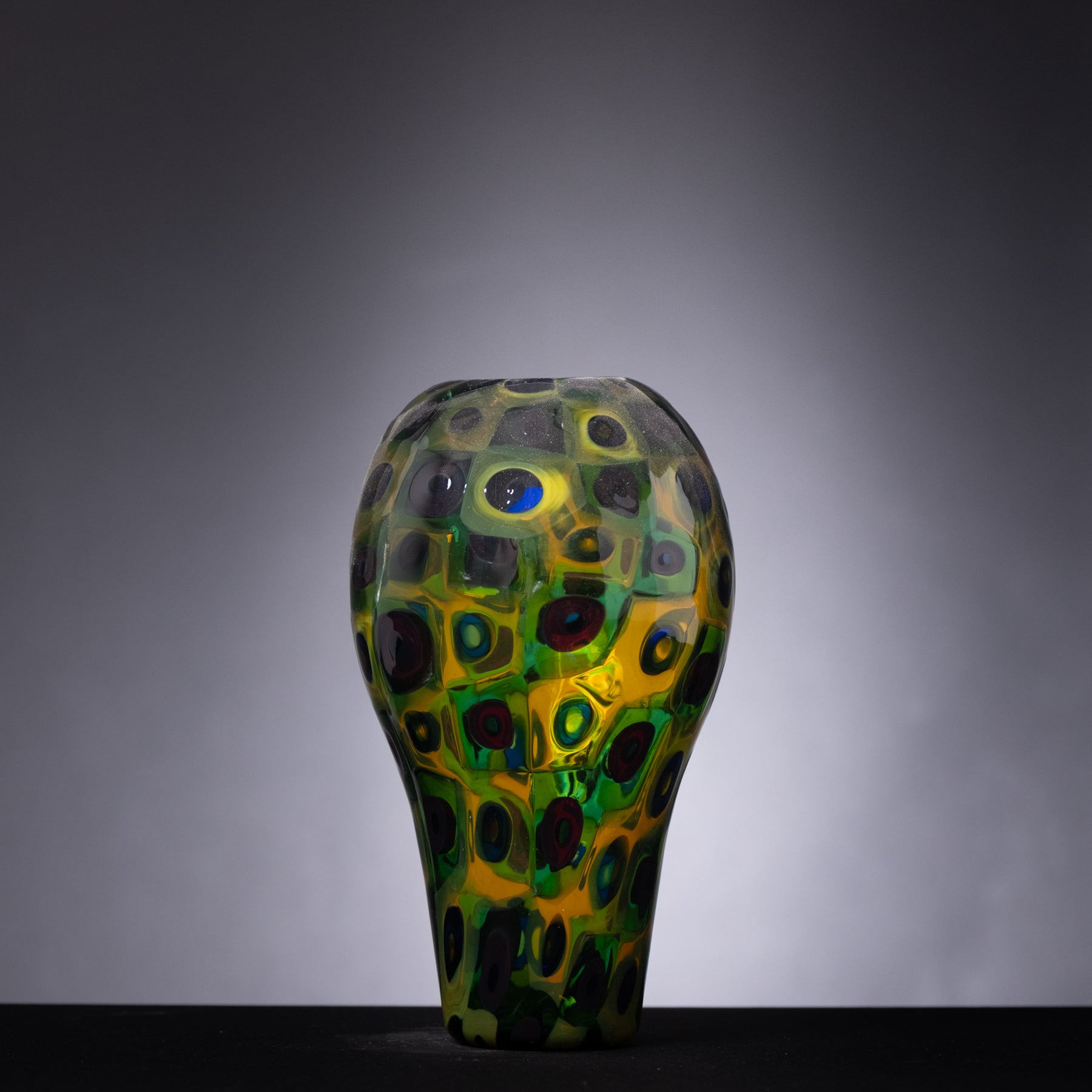 Decorative glass vase with a unique pattern on a gray background