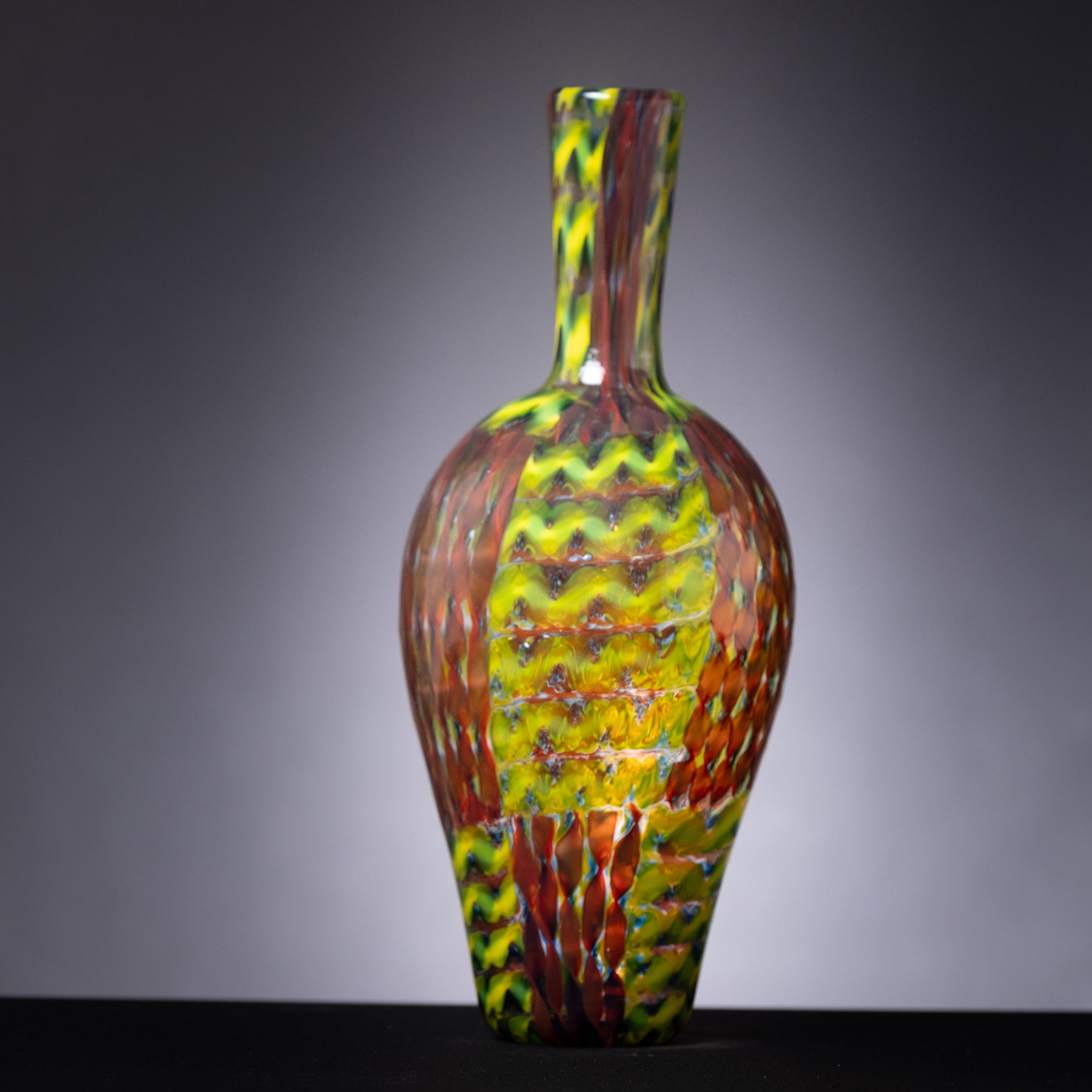 Multicolored glass vase on a gray background