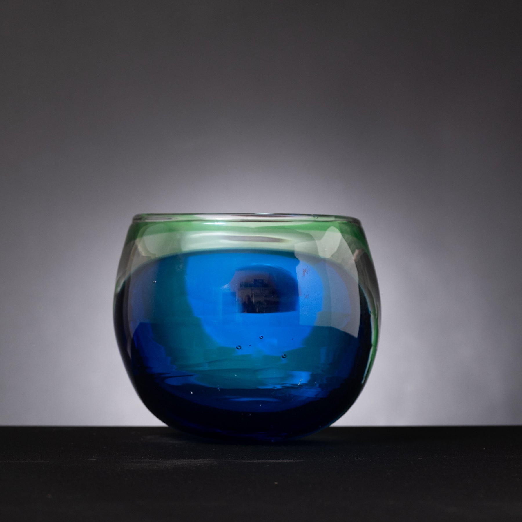 Blue glass vase on a dark background