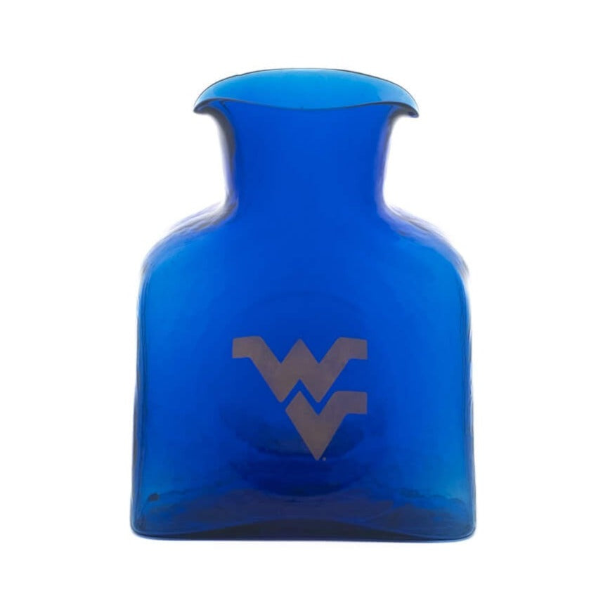 A cobalt blue glass bottle with a flared neck, featuring an etched gray WV logo on the front, set against a plain white background.