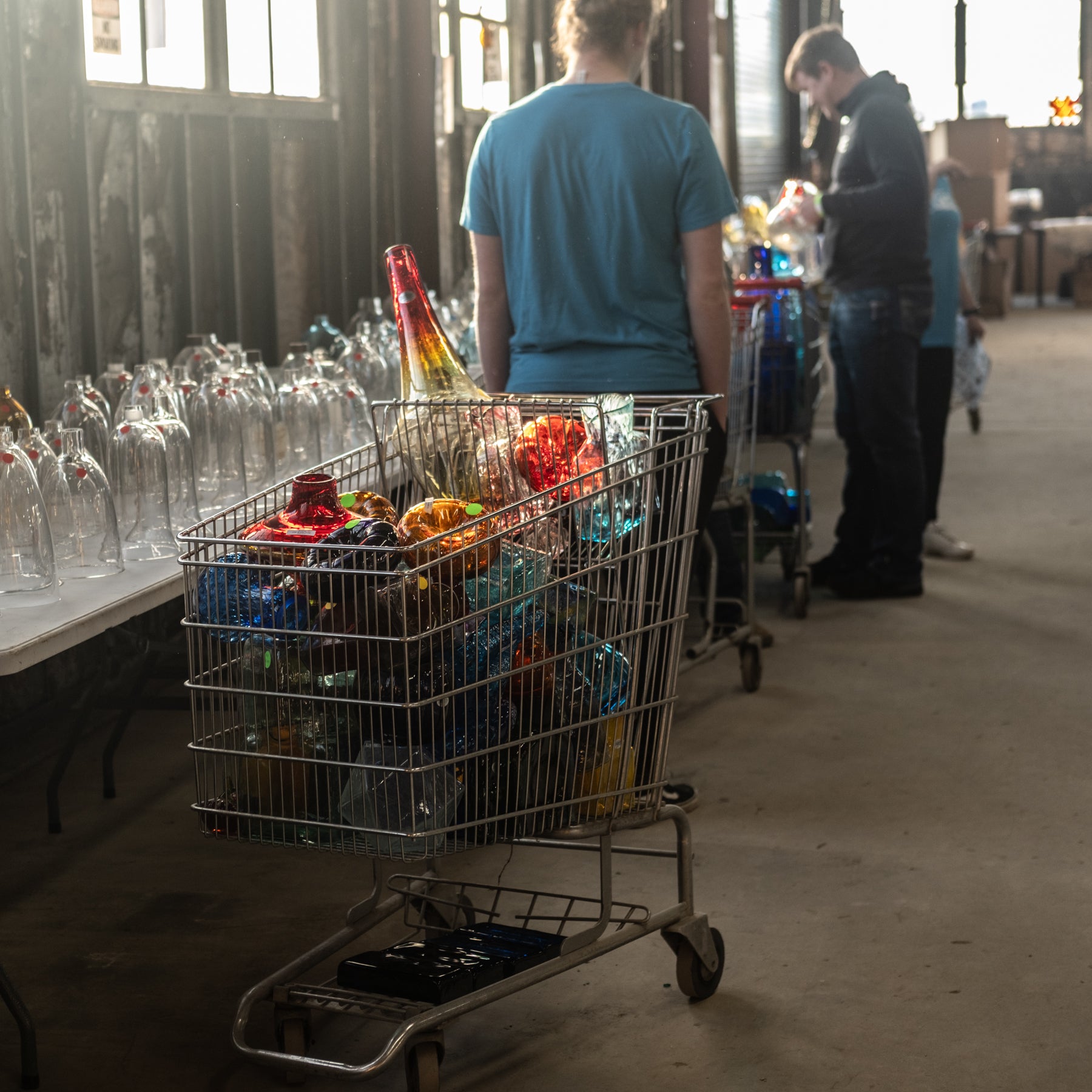 Cart filled with colorful bottles in a warehouse setting