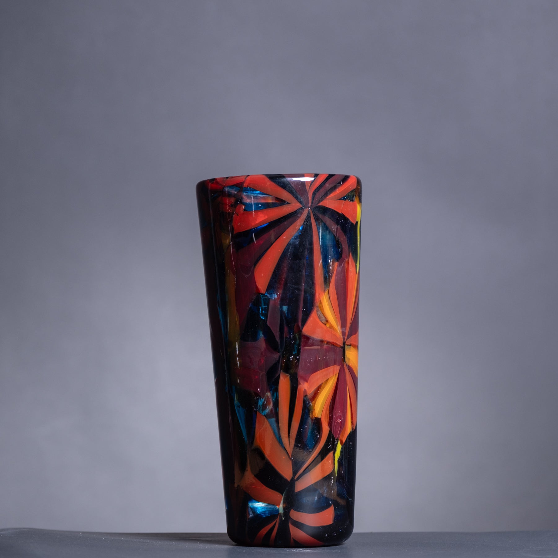 Decorative vase with colorful abstract design on a gray background