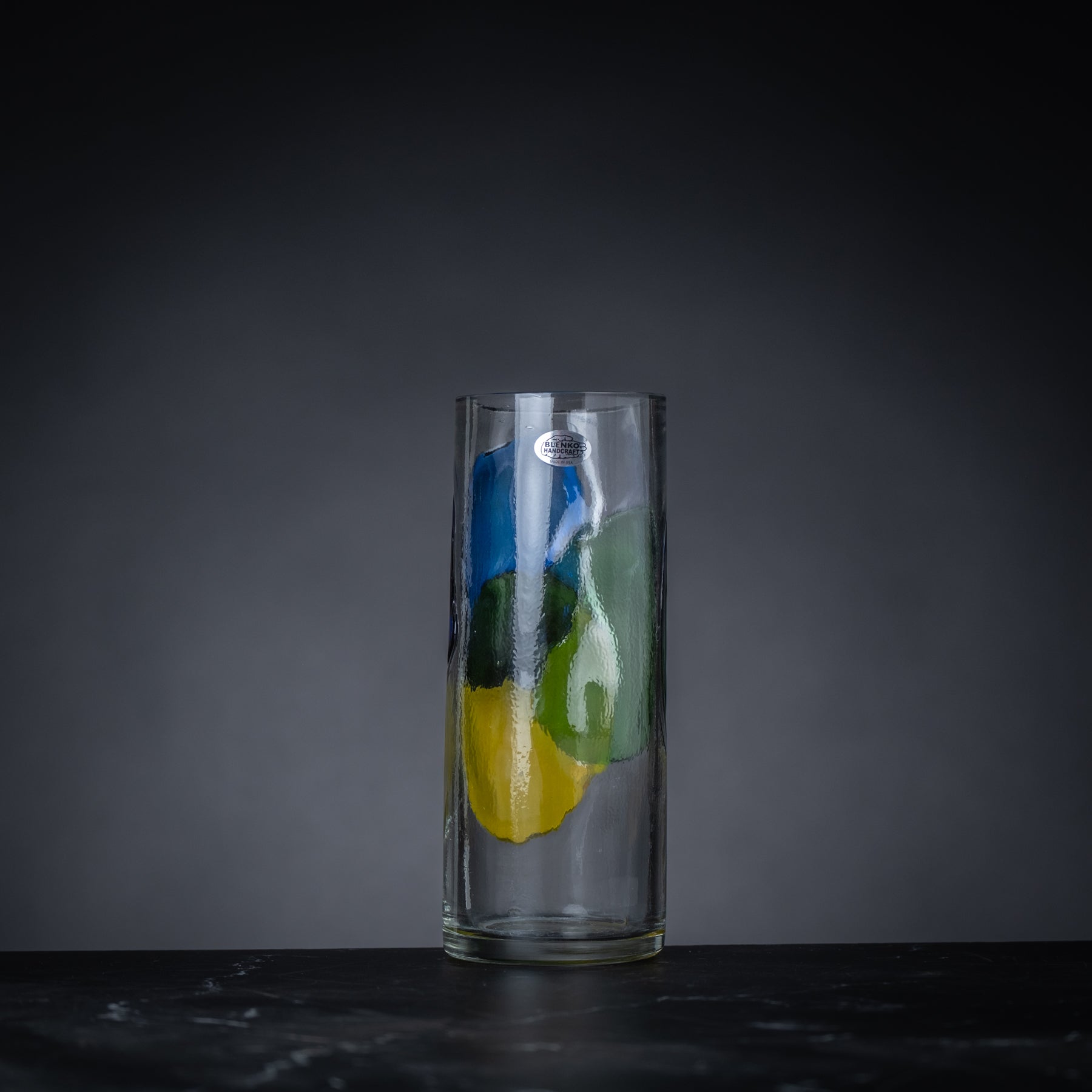 Clear glass vase with colorful design on a dark background