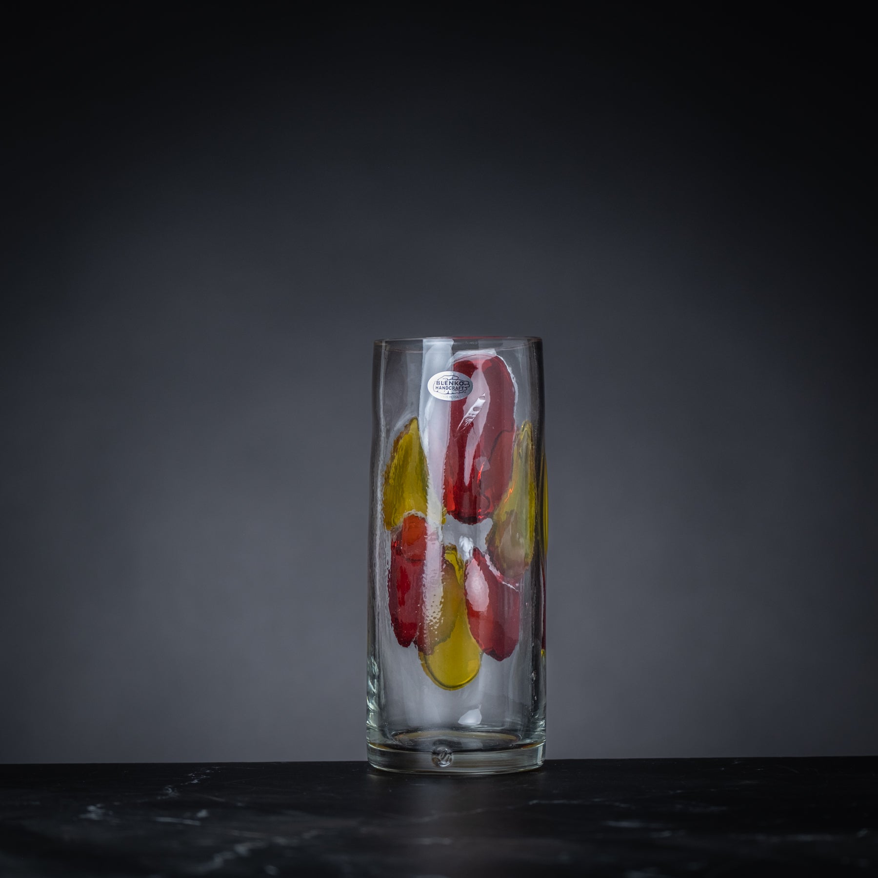 Clear glass with colorful design on a dark background