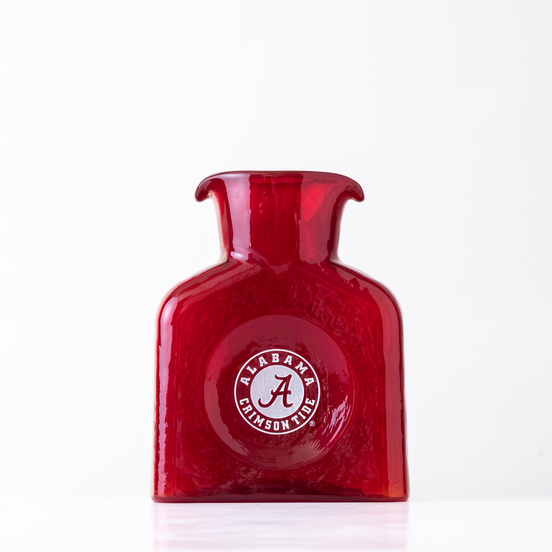 Red glass bottle with Alabama logo on a white background