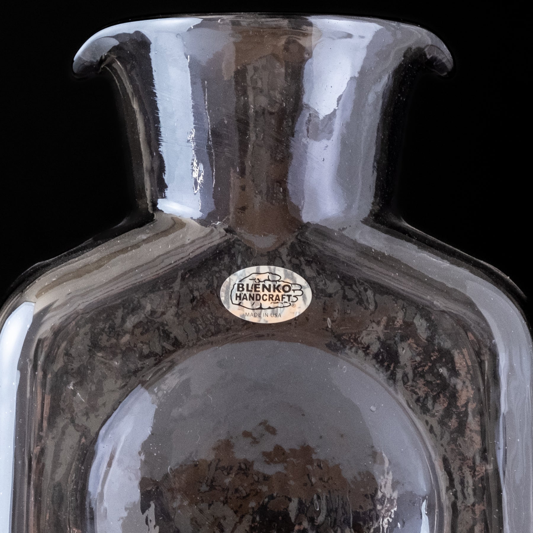 Purple vase with 'Blenko Handcraft' label on a black background