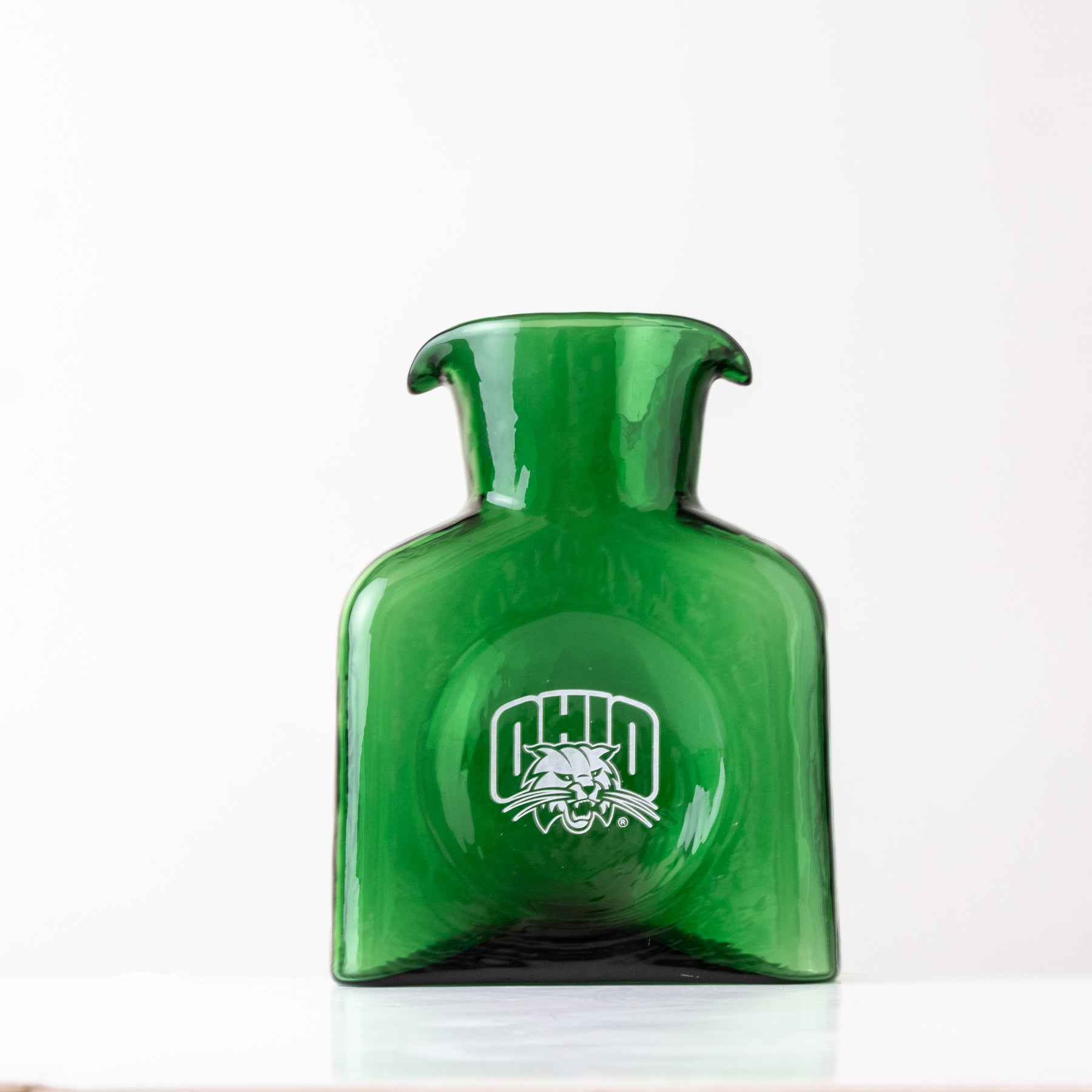 Green glass vase with a logo on a white background