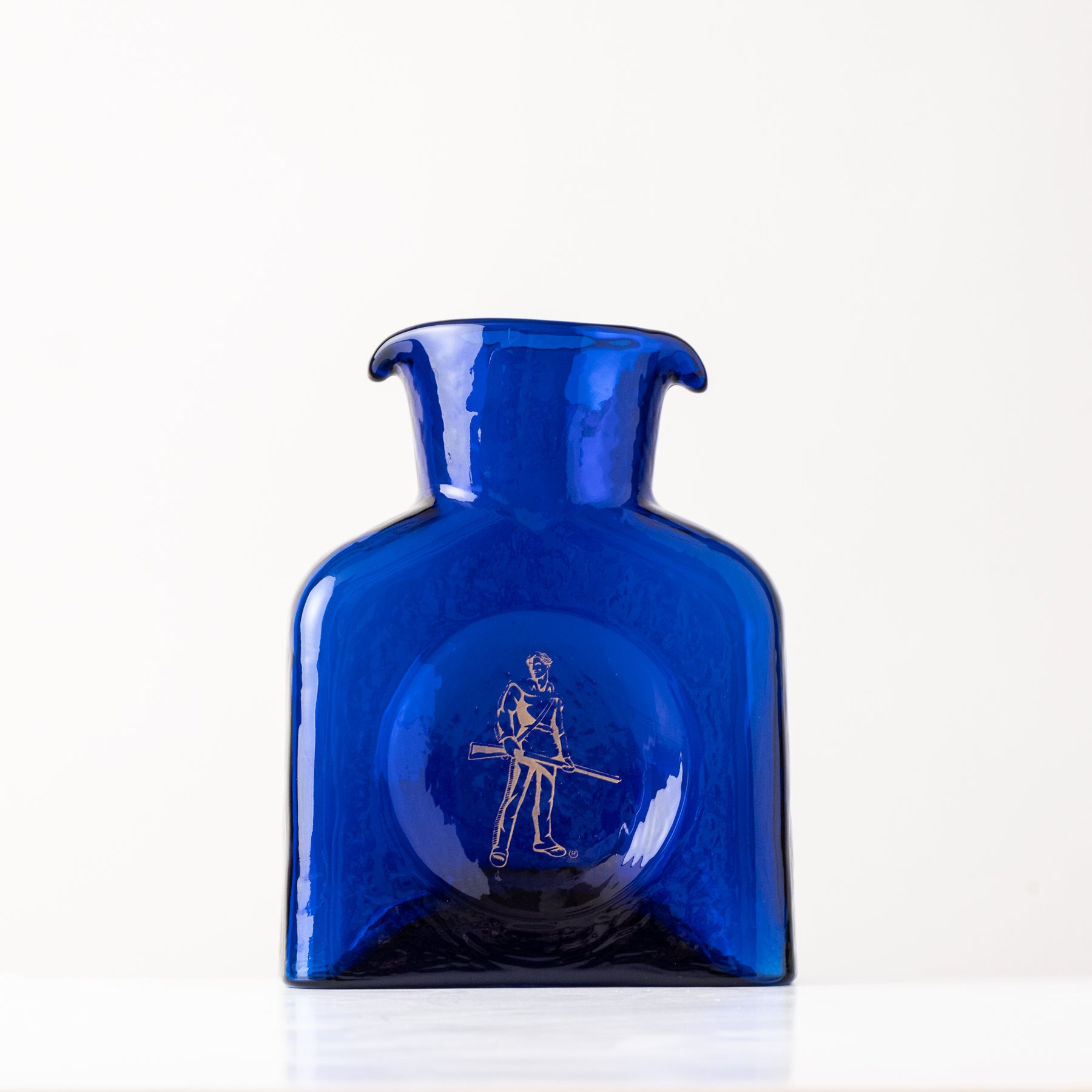 Blue glass bottle with a white cap on a white background