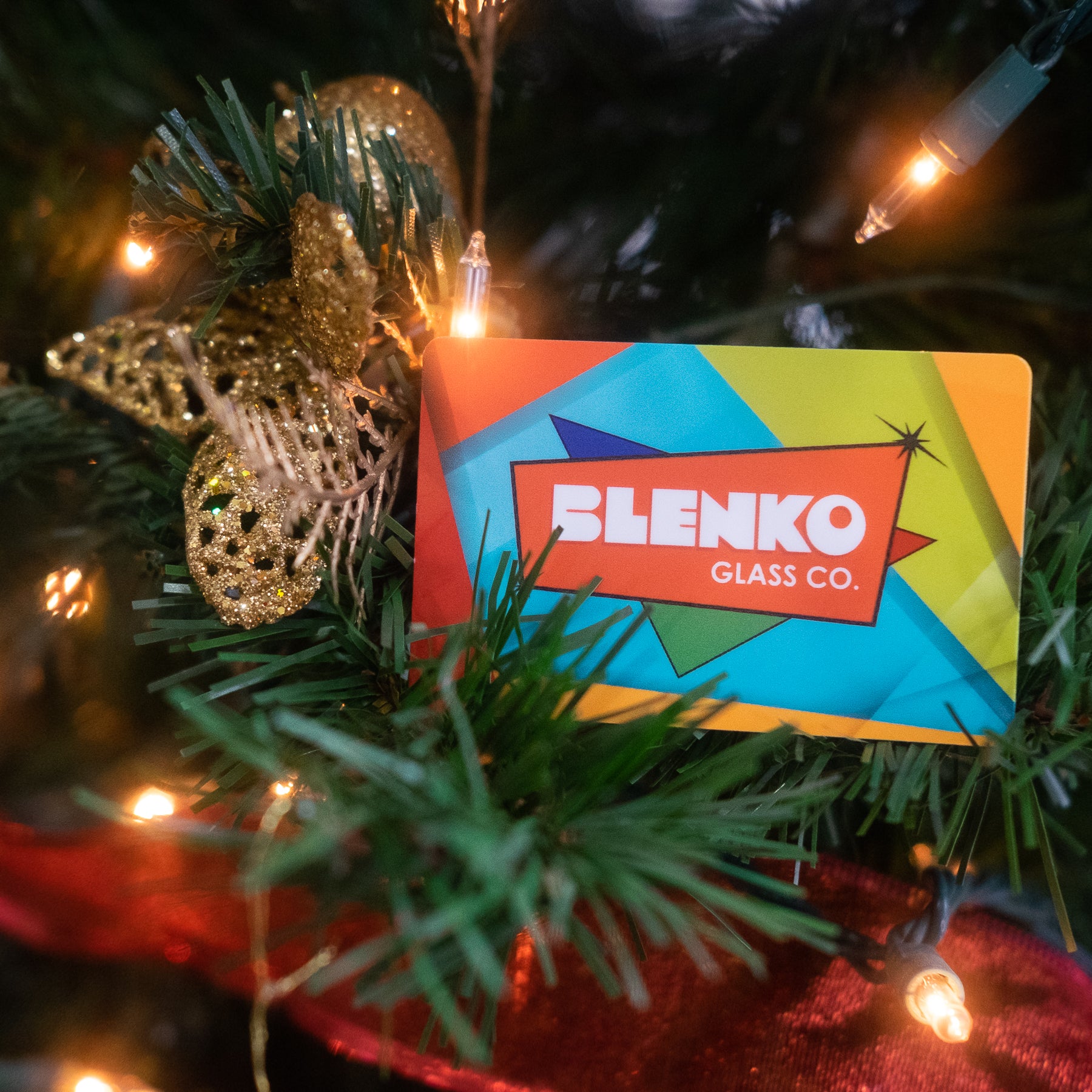 An e-gift certificate from Blenko Glass Co. displayed on a Christmas tree.
