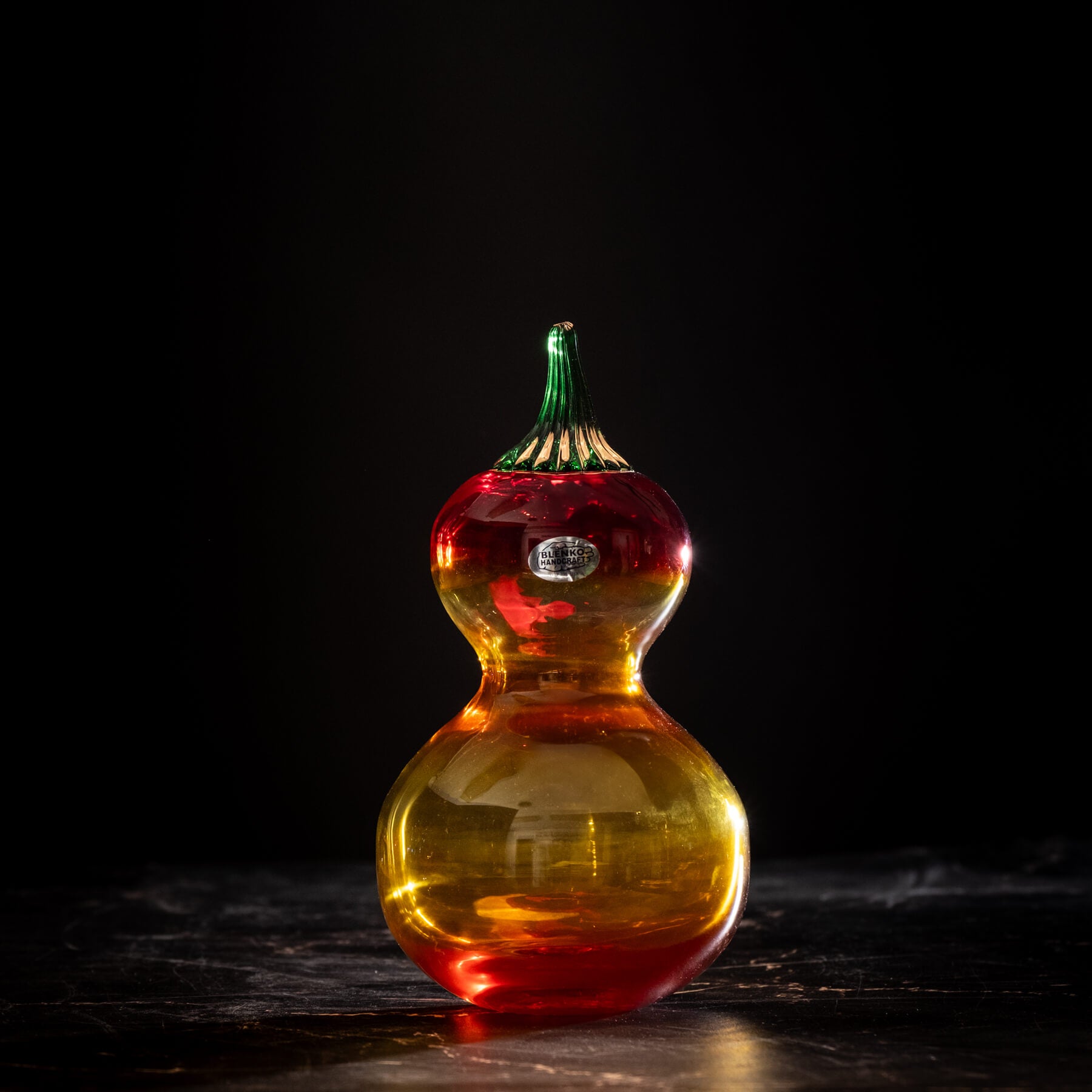 Colorful glass calabash gourd on a dark background