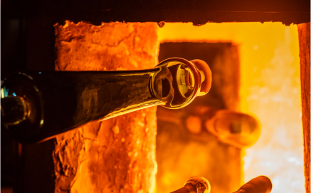 Glass item being heated in a glowing fiery furnace