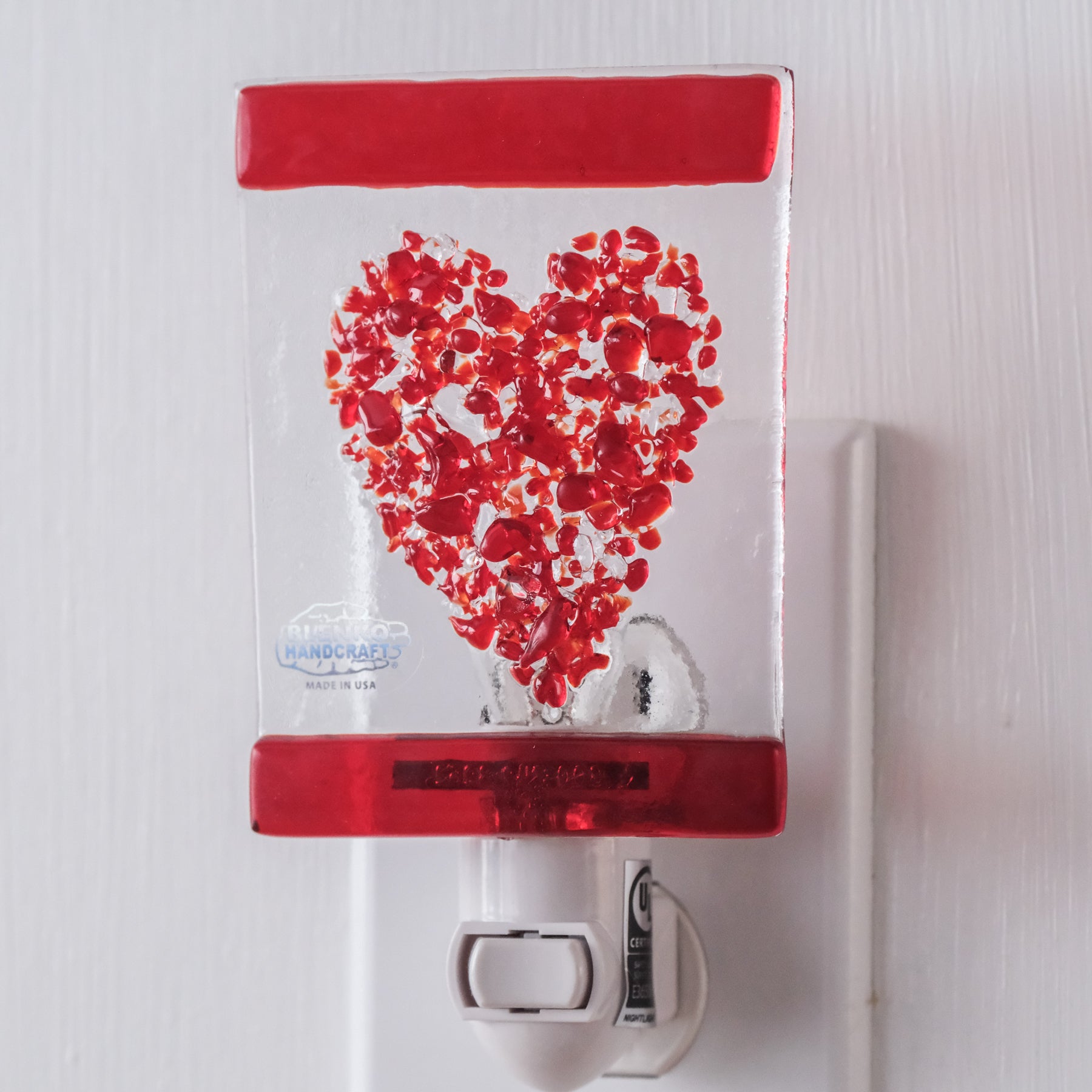 Crystal rectangle with red heart design on white wall