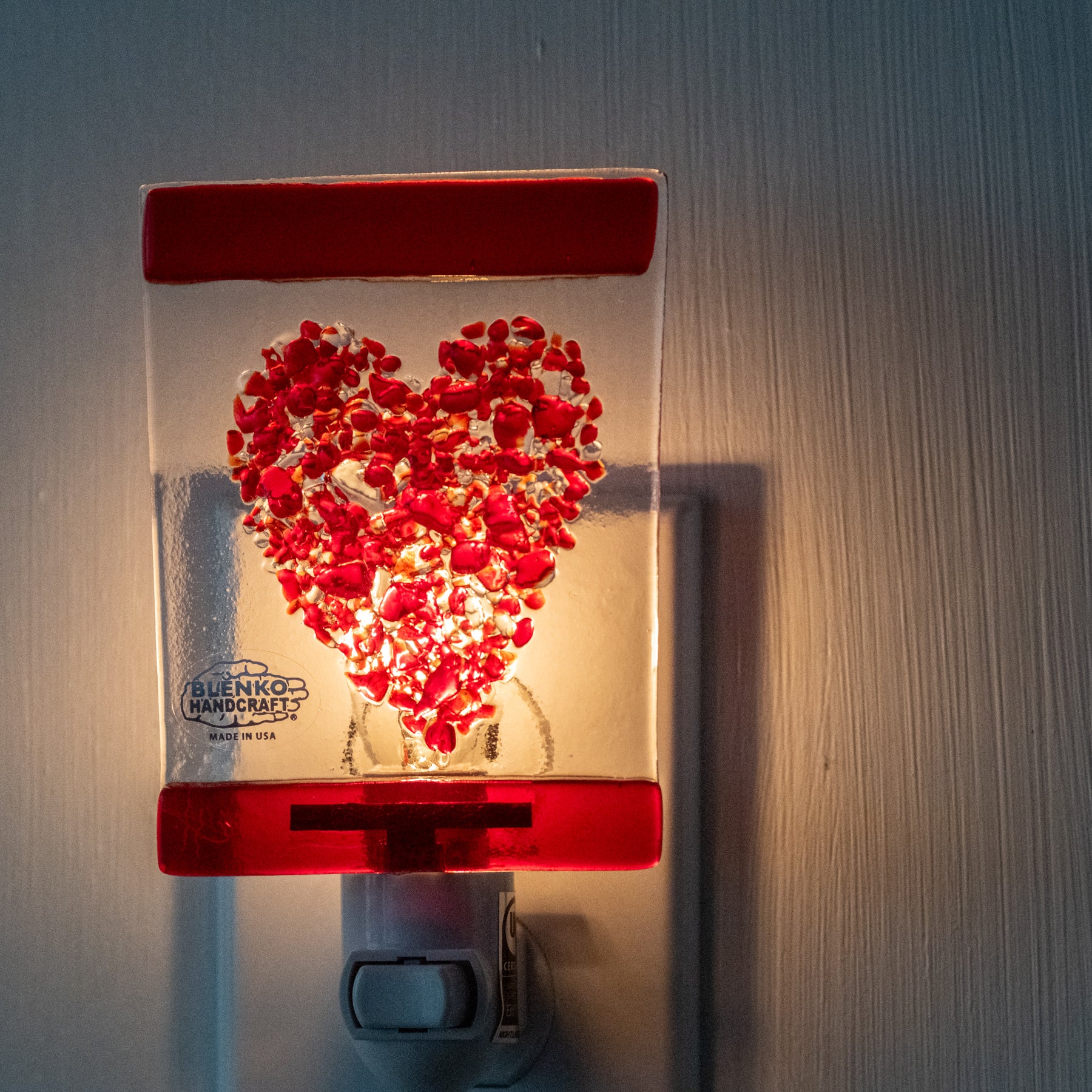 Crystal rectangle with red heart design on white wall
