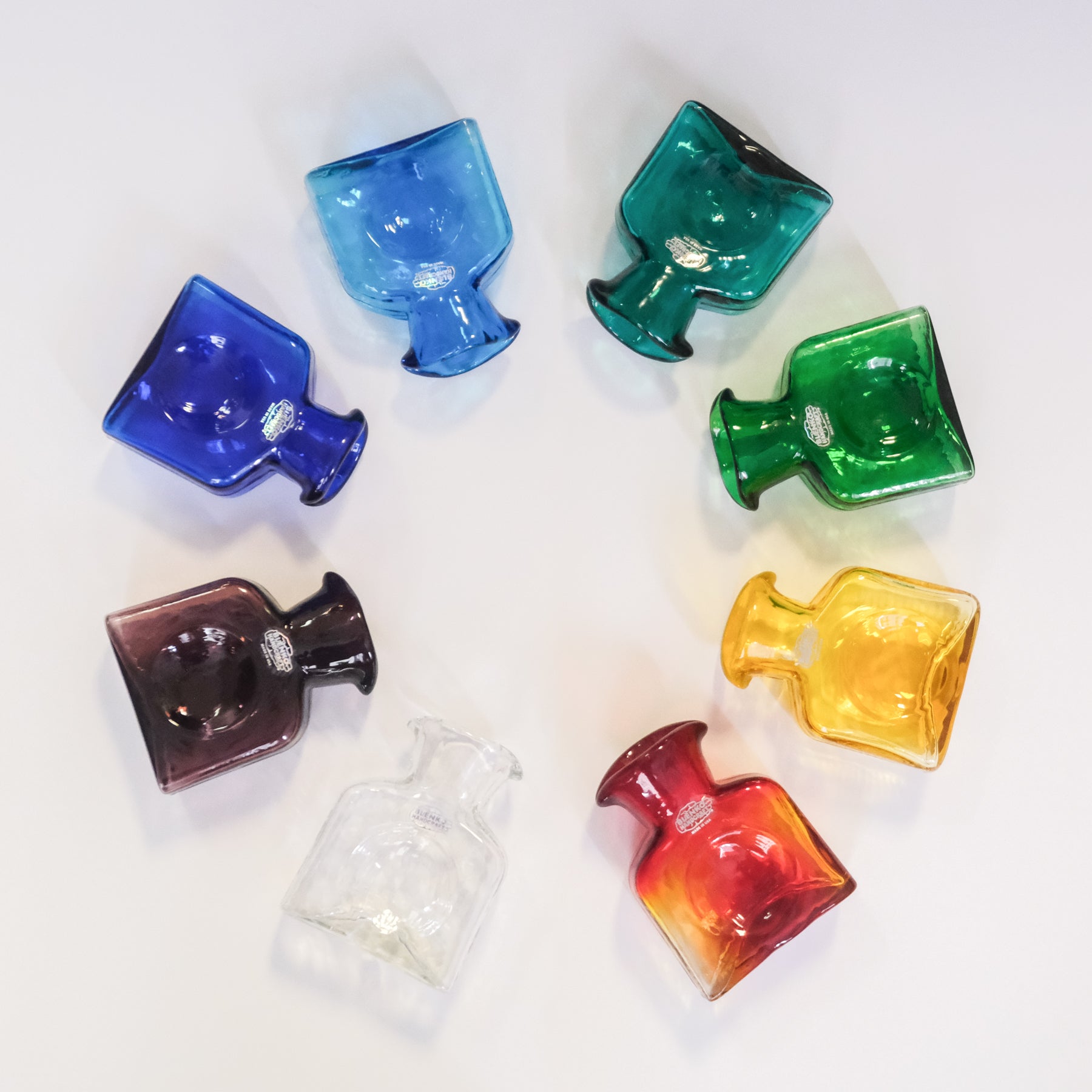 Set of colorful glass bottles on a white background