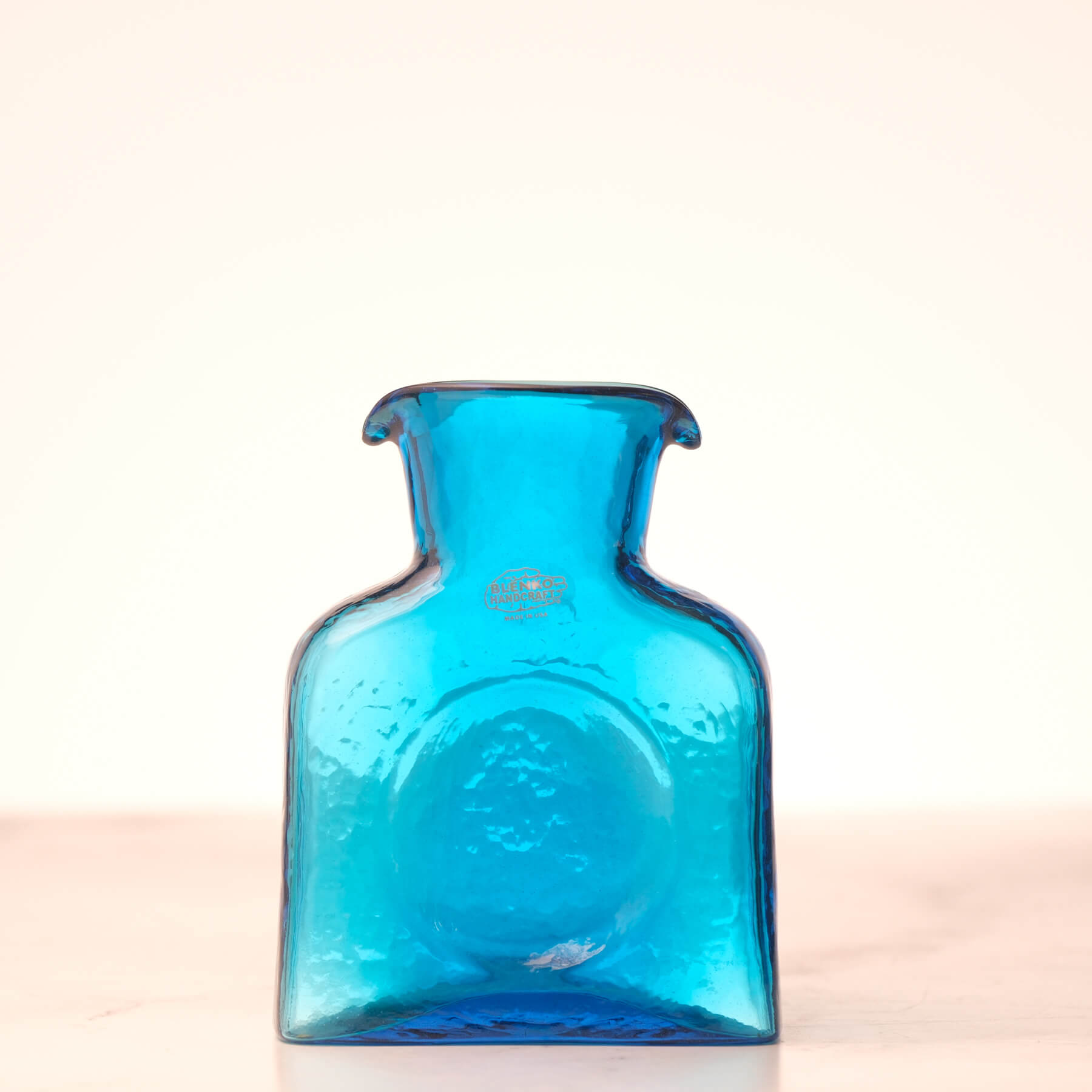 Blue glass bottle on a white background