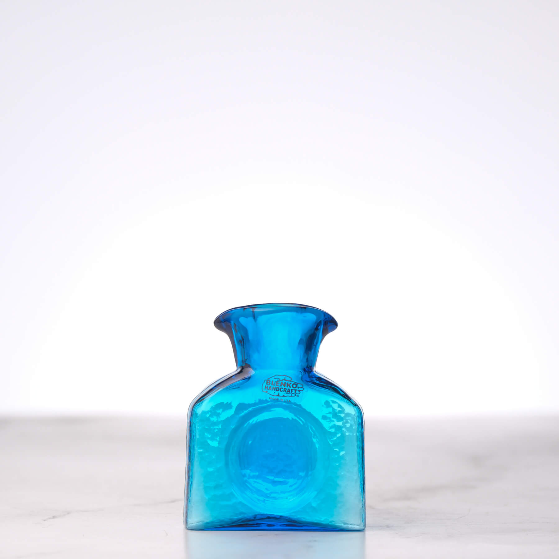 Blue glass bottle on a white background