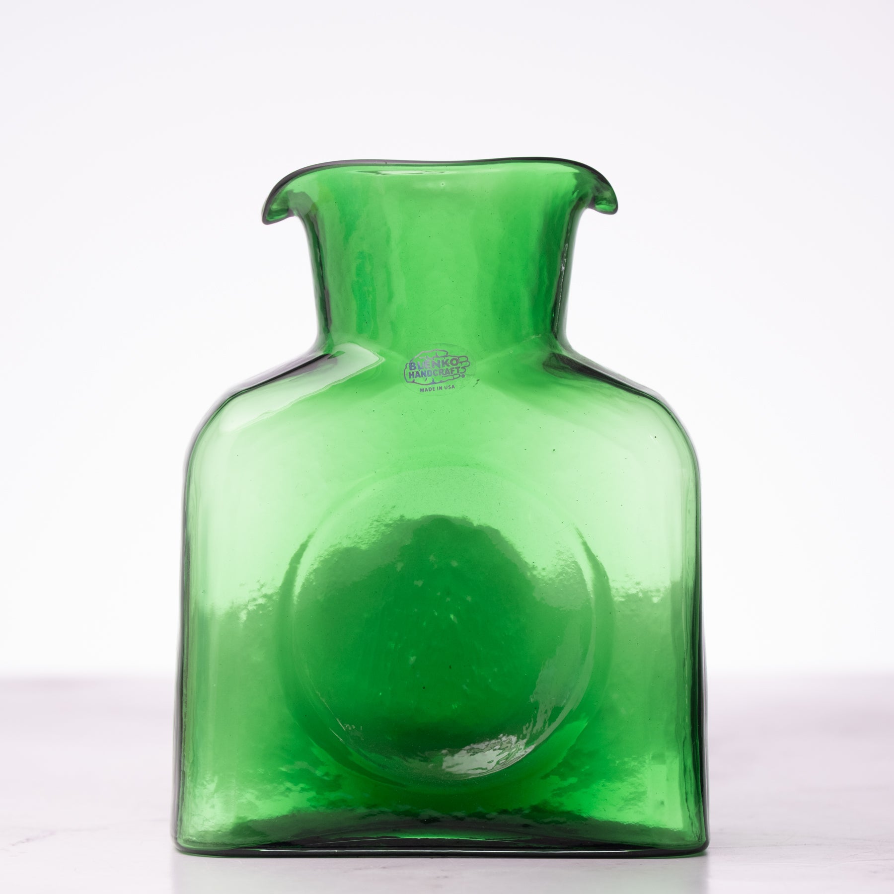 Green glass vase on a white background