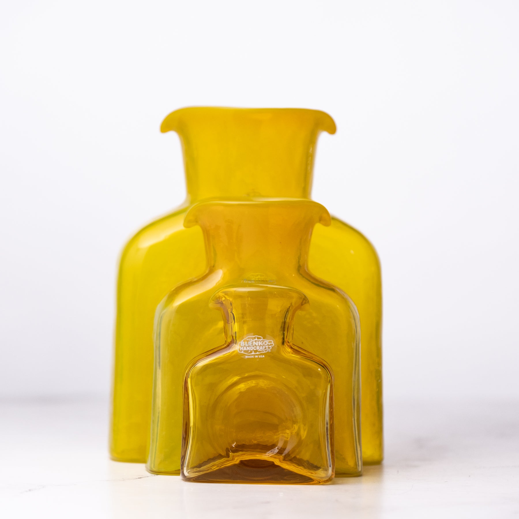 Yellow glass bottle on a white background