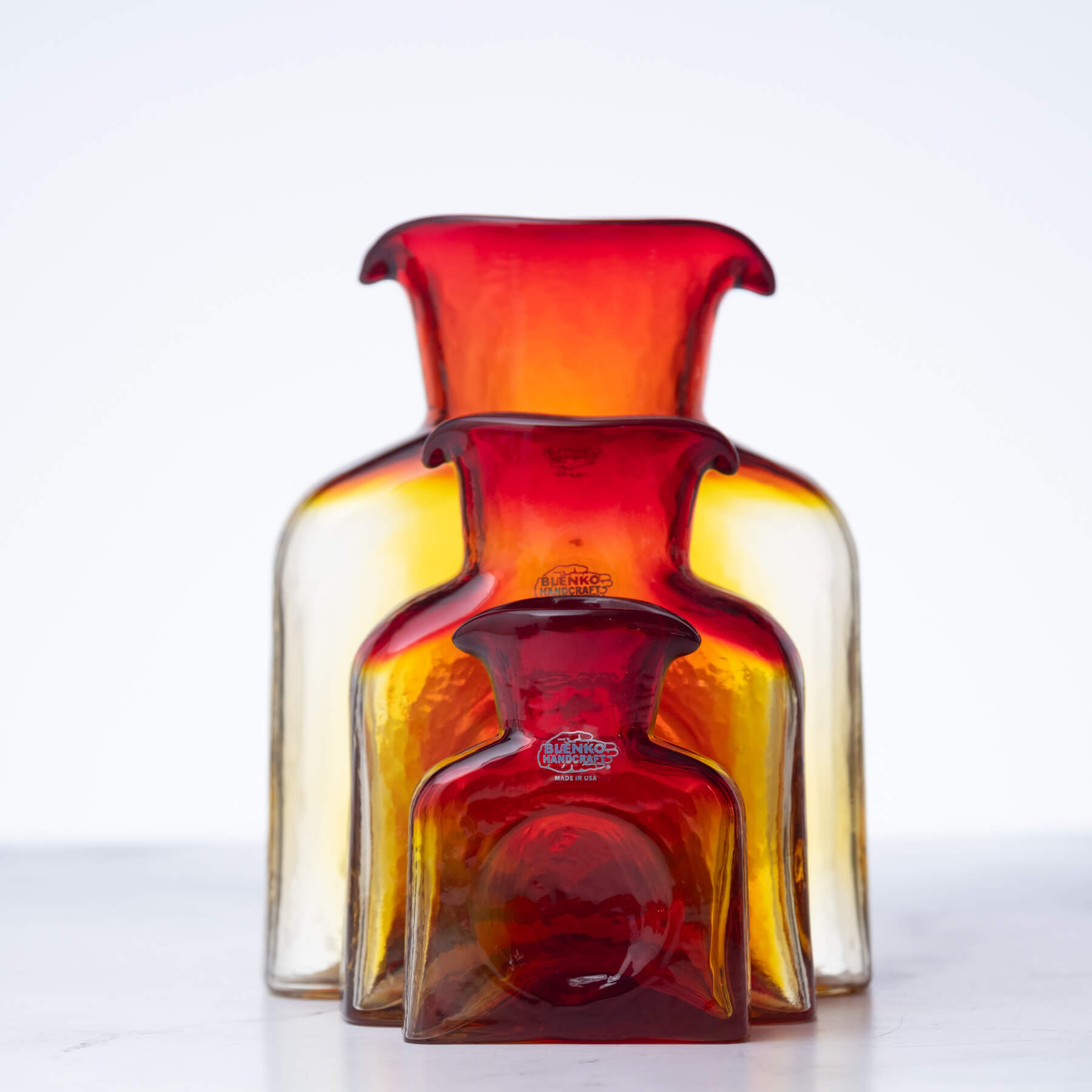 Red and orange glass vase on a white background