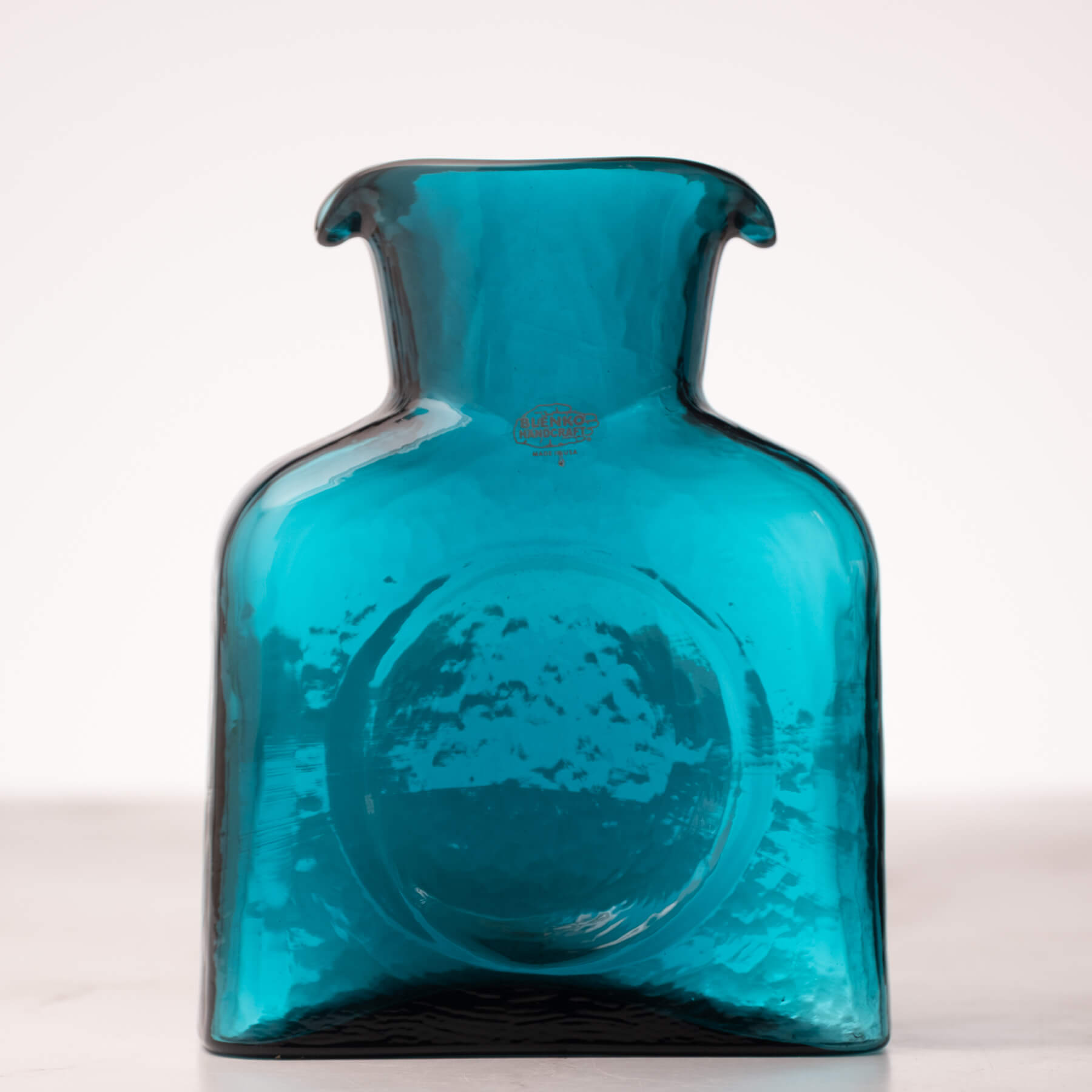 Blue glass vase on a white background