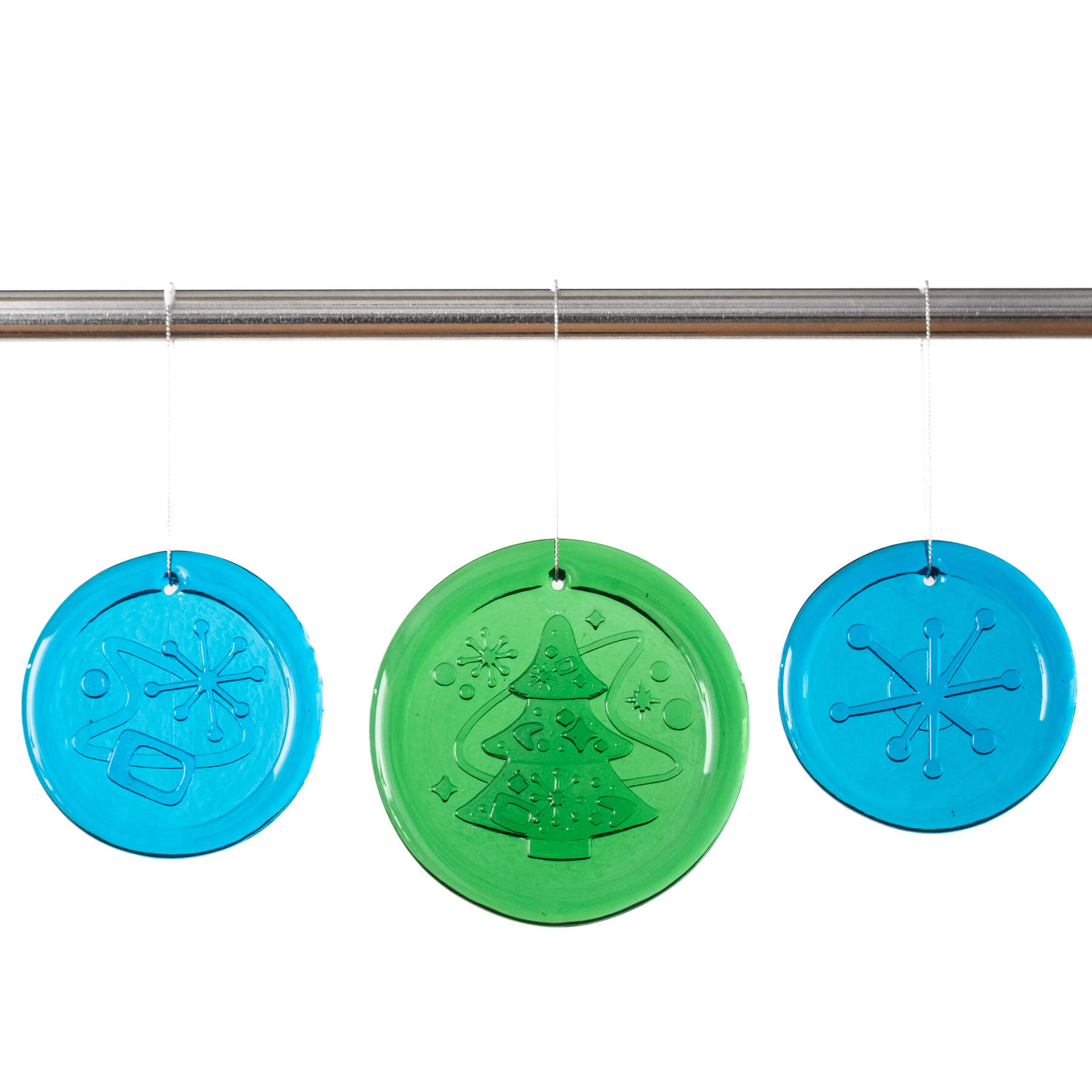 Three round Christmas-themed window clings in blue and green hanging on a rod.