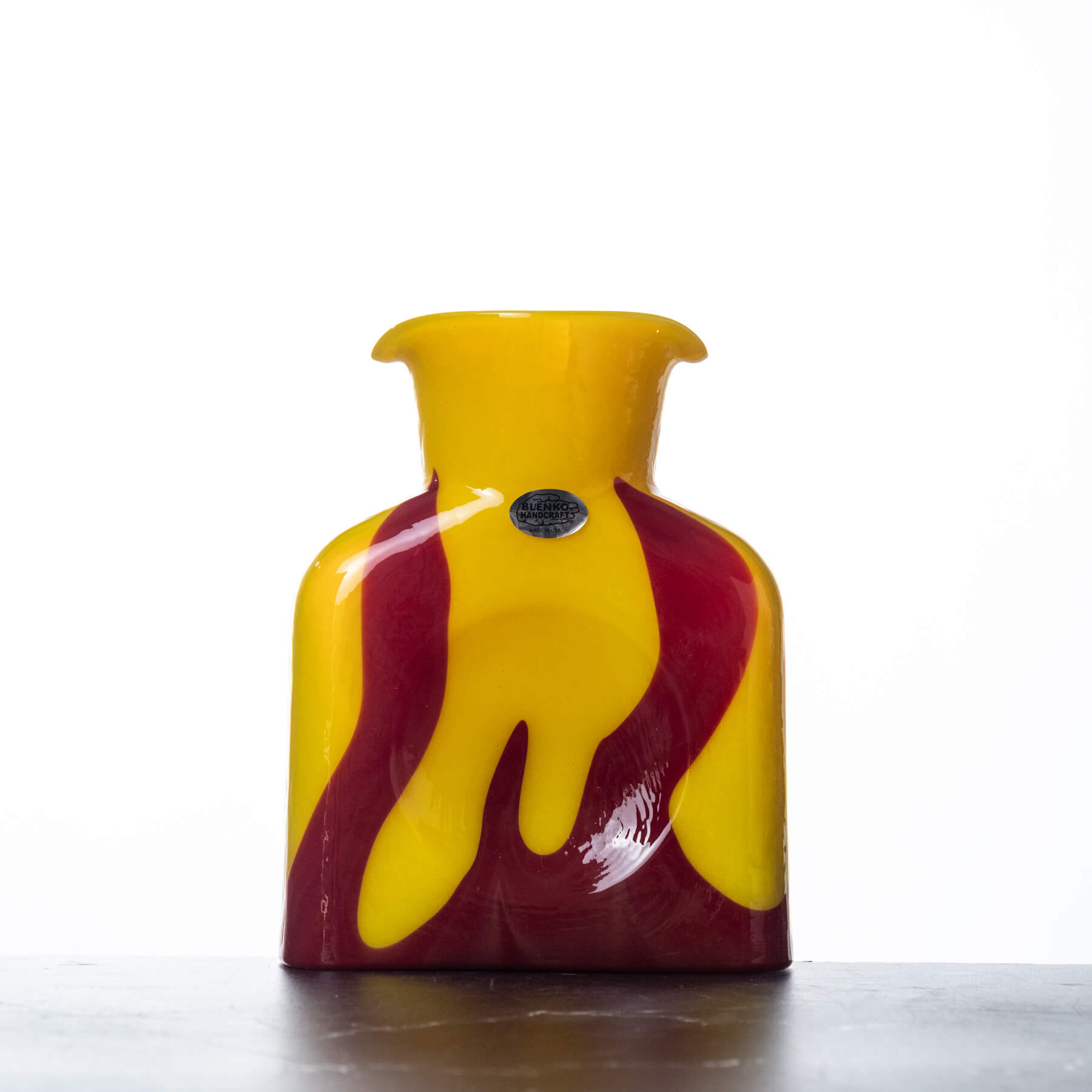 Yellow and red glass vase on a white background
