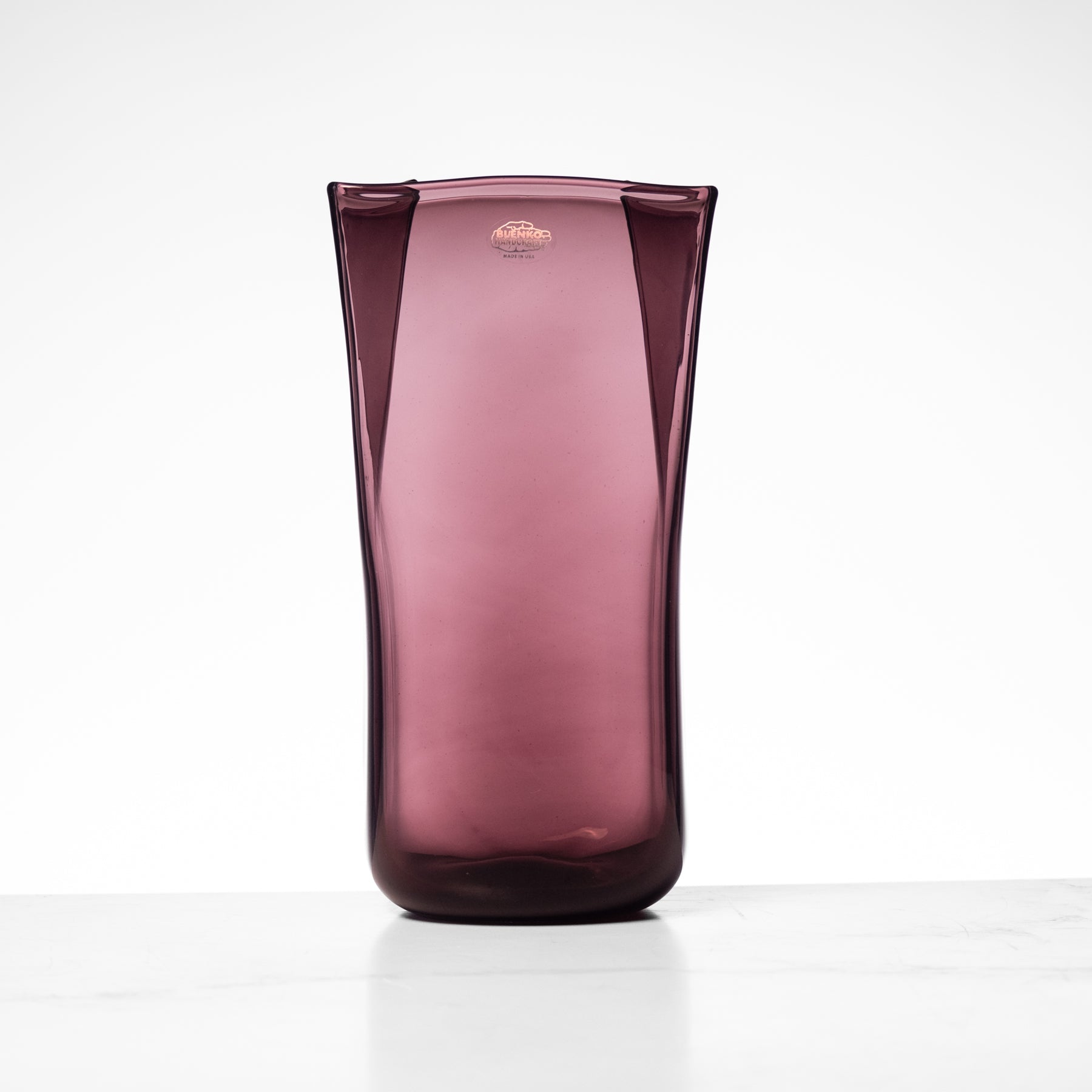 Purple glass vase on a white background