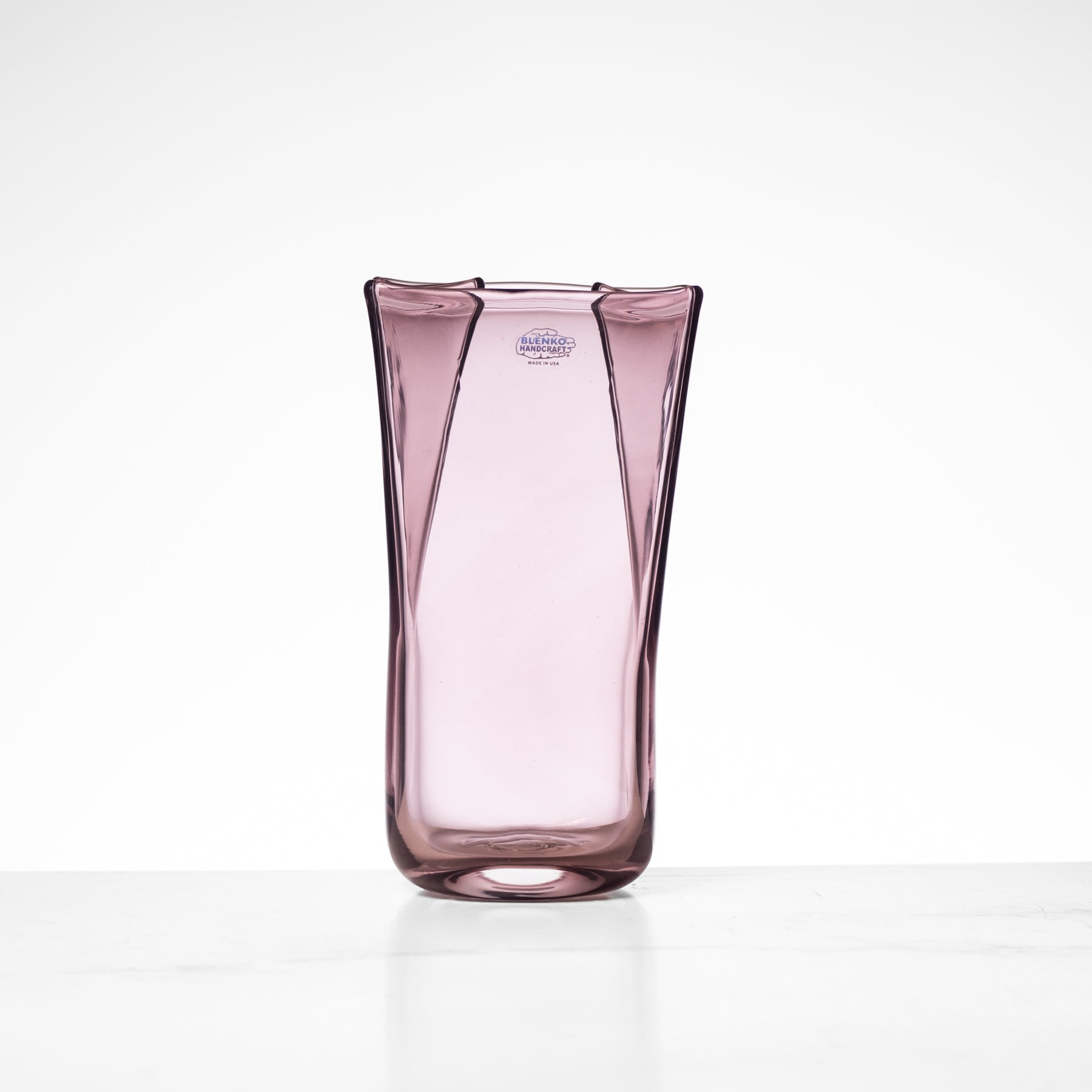 Pink glass vase on a white background